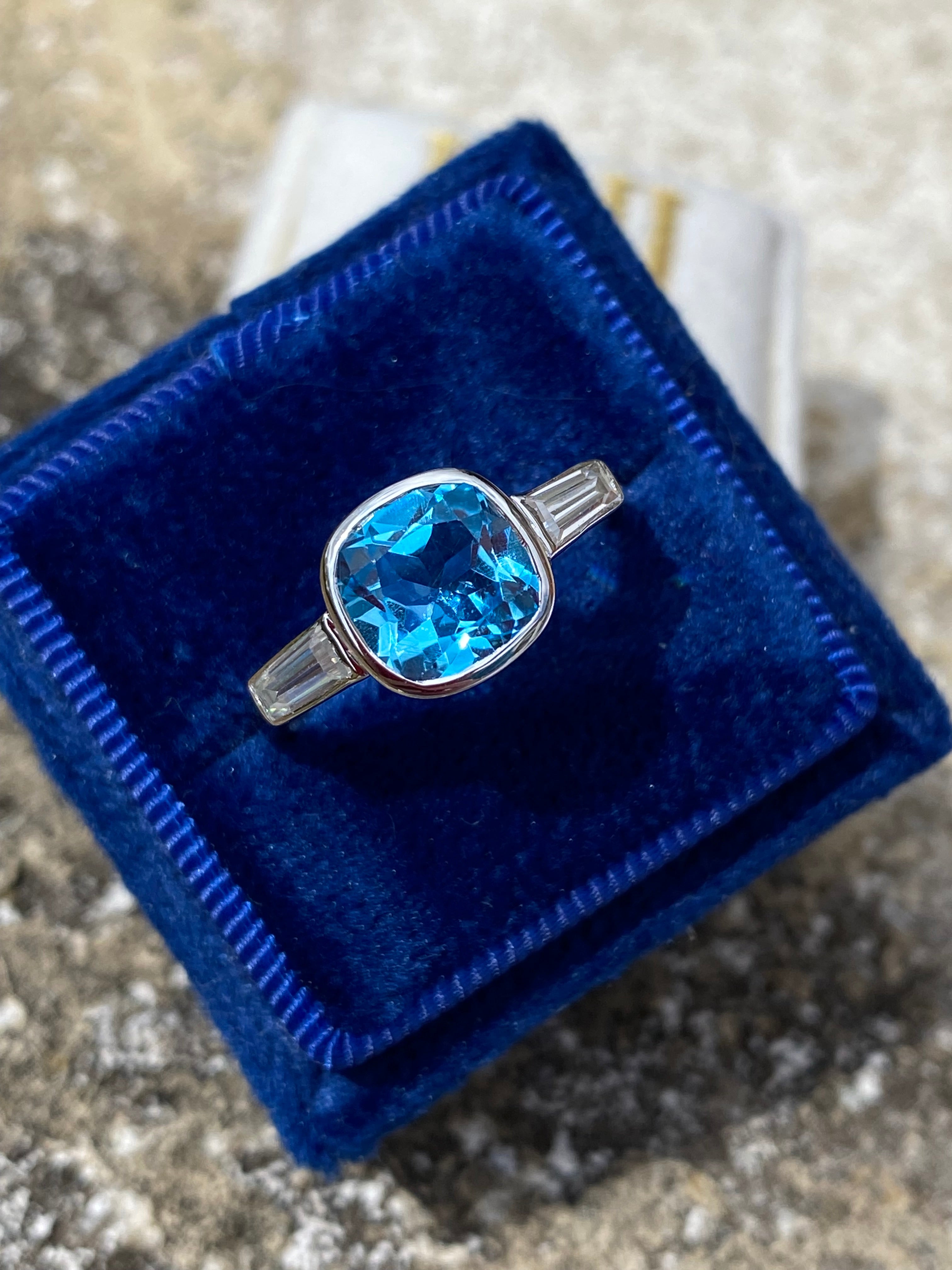 2.33 Carat Cushion Cut Blue Topaz and Moissanite Three Stone Ring in Sterling Silver