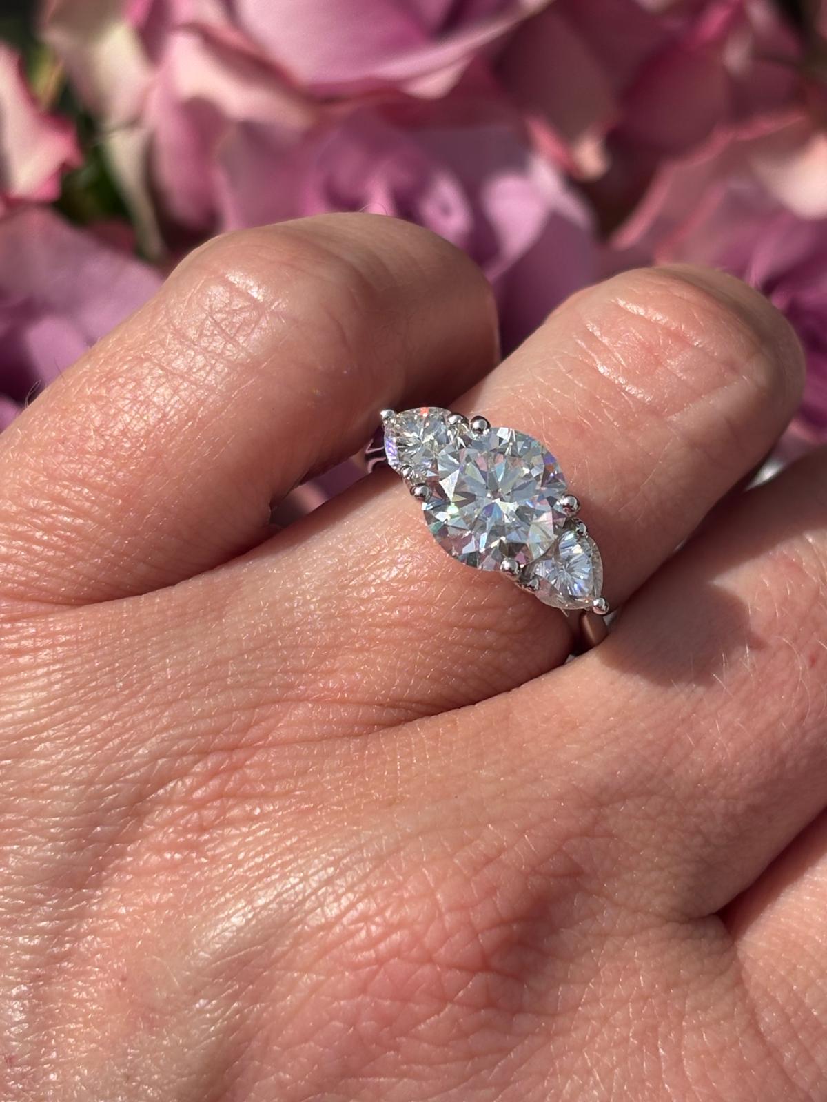 3.40 CTW Round and Heart Shape Moissanite Three Stone Ring in Sterling Silver