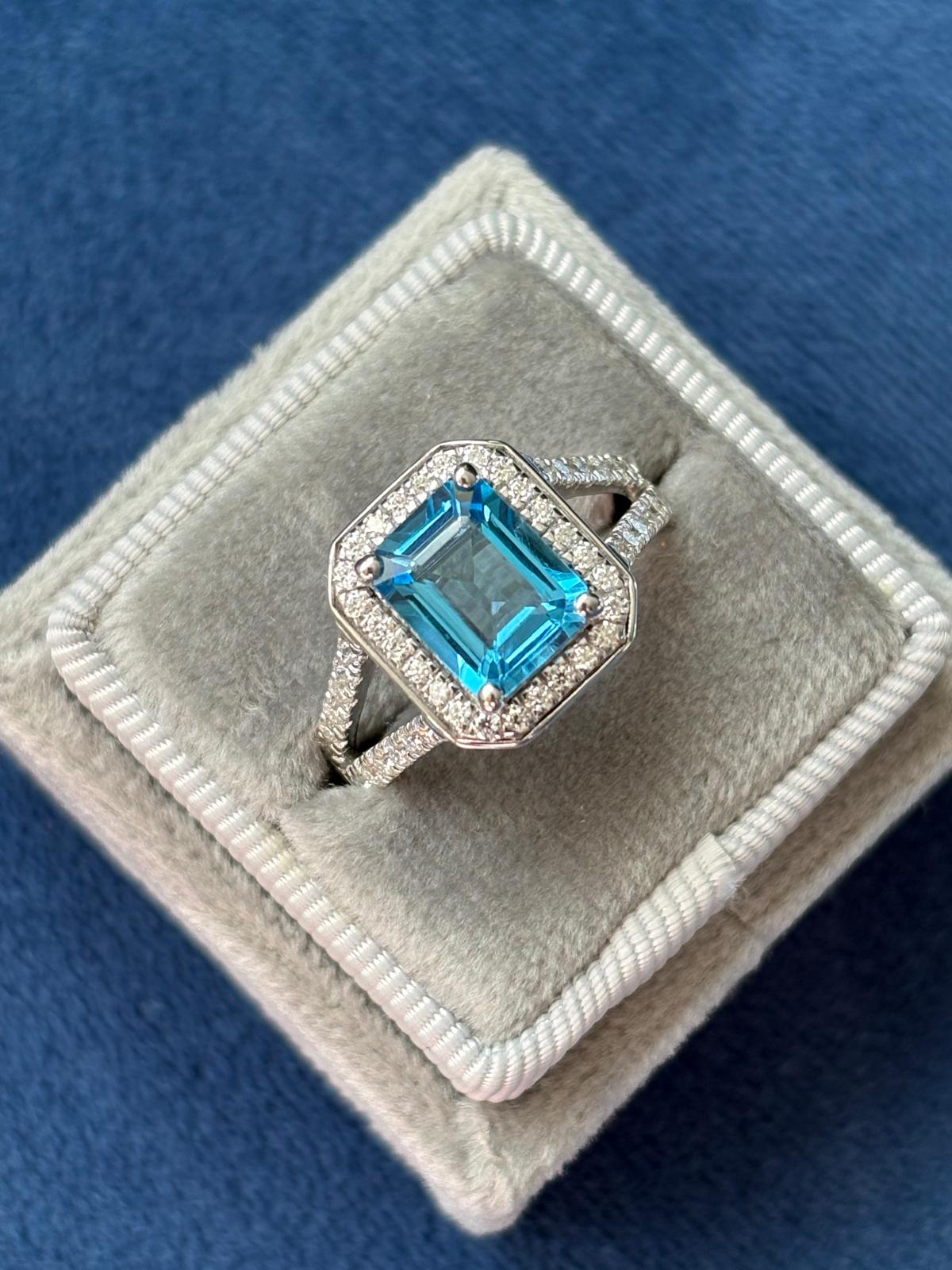 3.10 CTW Emerald Cut Moissanite and Blue Topaz Halo Ring in Sterling Silver