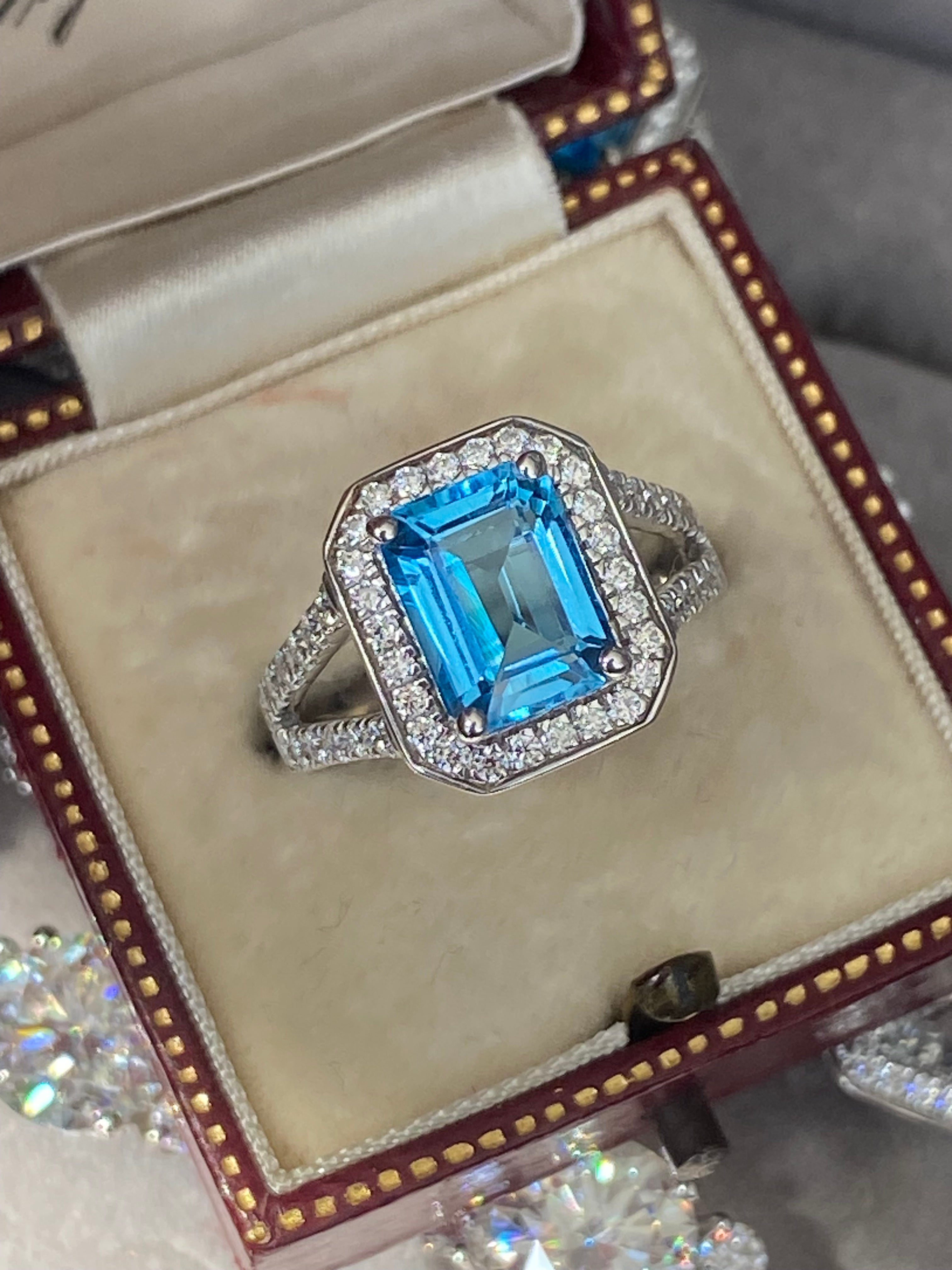 3.10 CTW Emerald Cut Moissanite and Blue Topaz Halo Ring in Sterling Silver