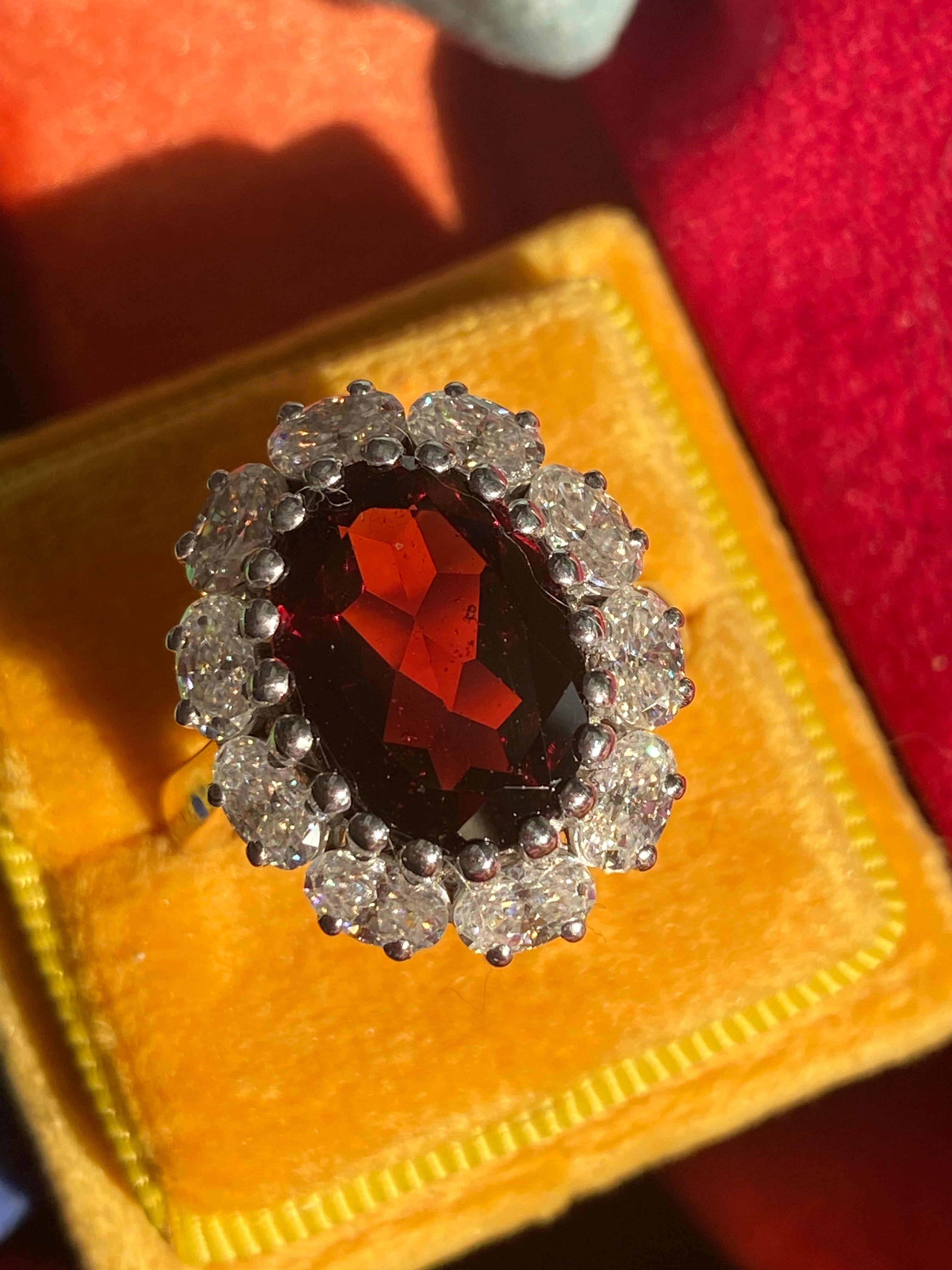 8.17 CTW Oval Cut Garnet and Moissanite Halo Cocktail Ring