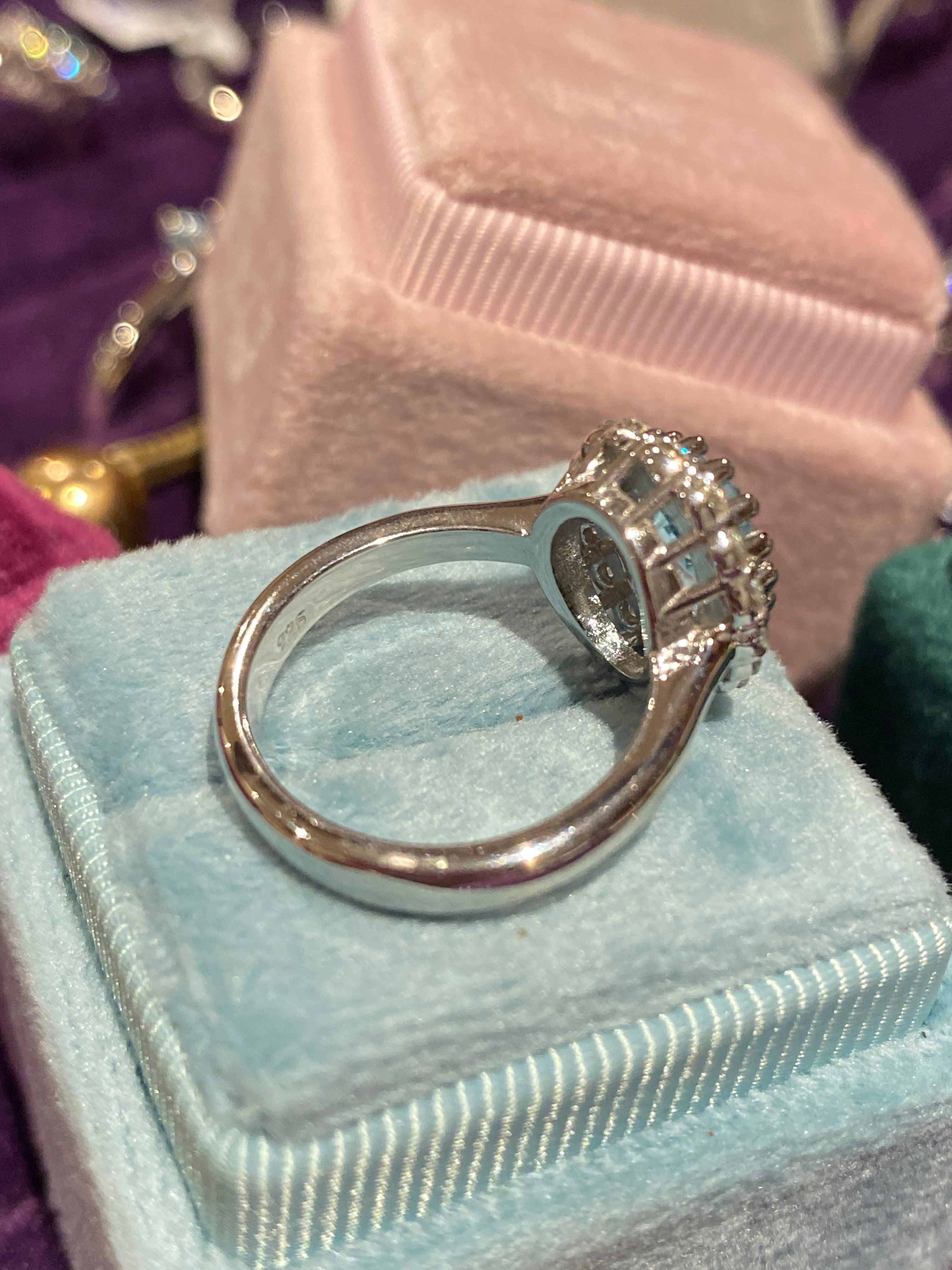2.33 CTW Oval Cut Blue Topaz and Moissanite Halo Cluster Ring in Sterling Silver