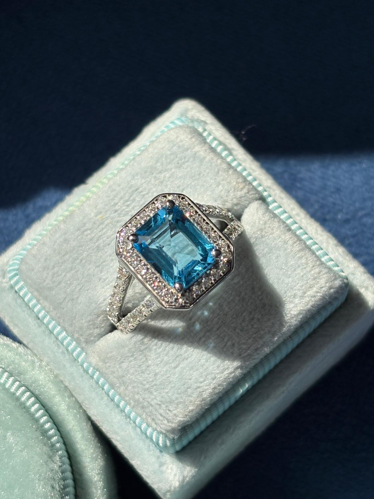 3.10 CTW Emerald Cut Moissanite and Blue Topaz Halo Ring in Sterling Silver