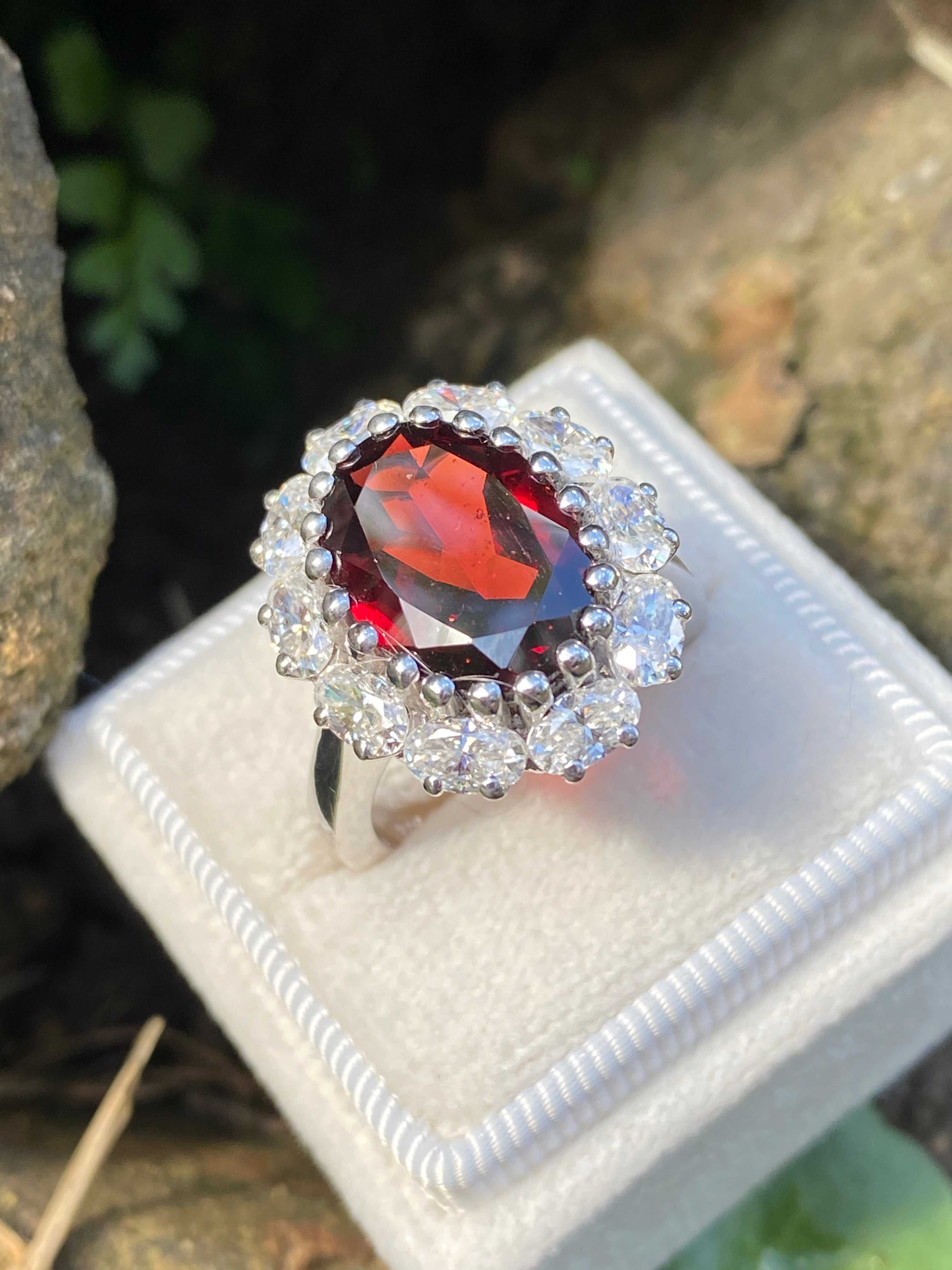 8.17 CTW Oval Cut Garnet and Moissanite Halo Cocktail Ring