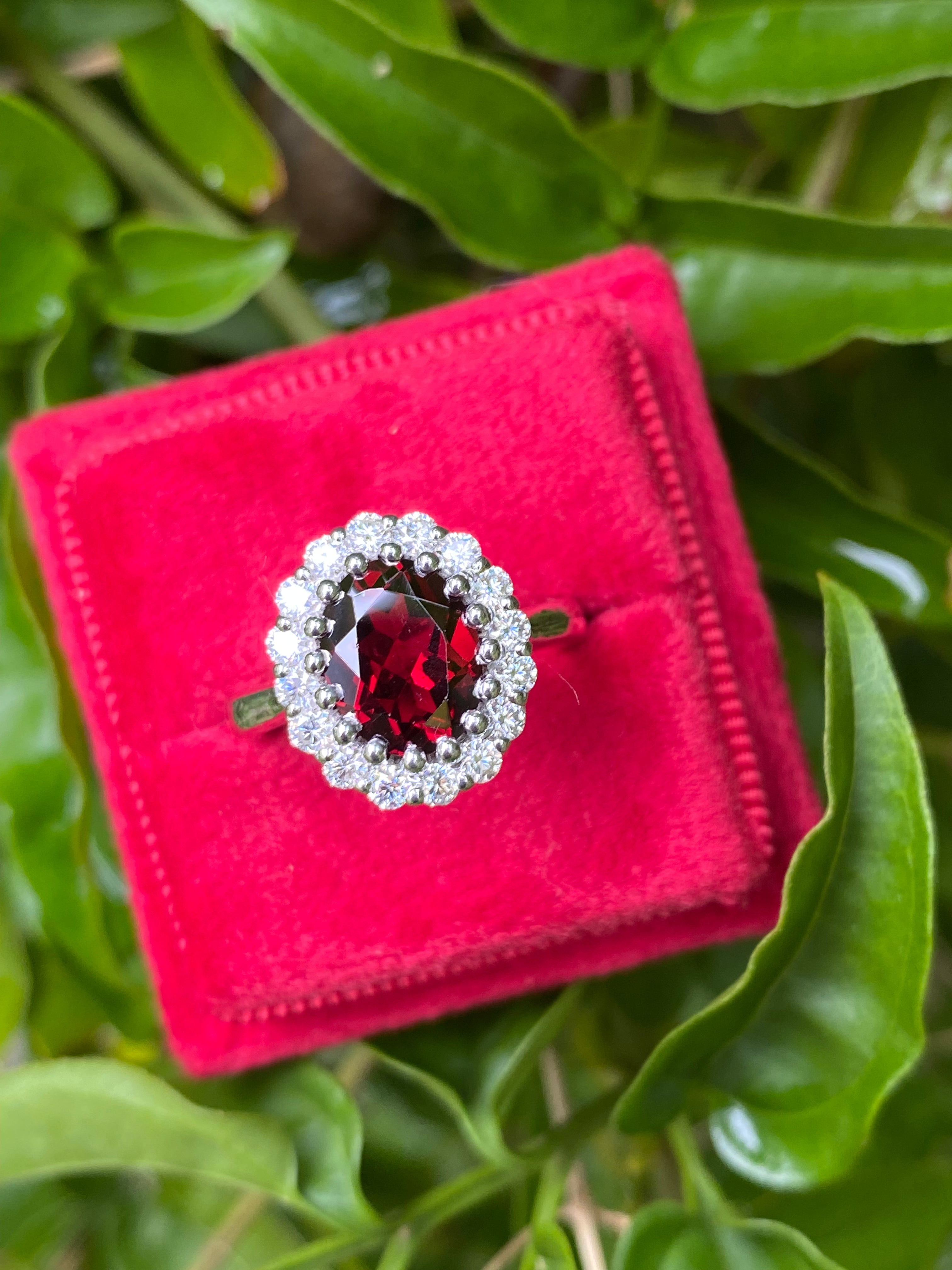2.33 CTW Oval Cut Garnet and Moissanite Halo Ring in Sterling Silver