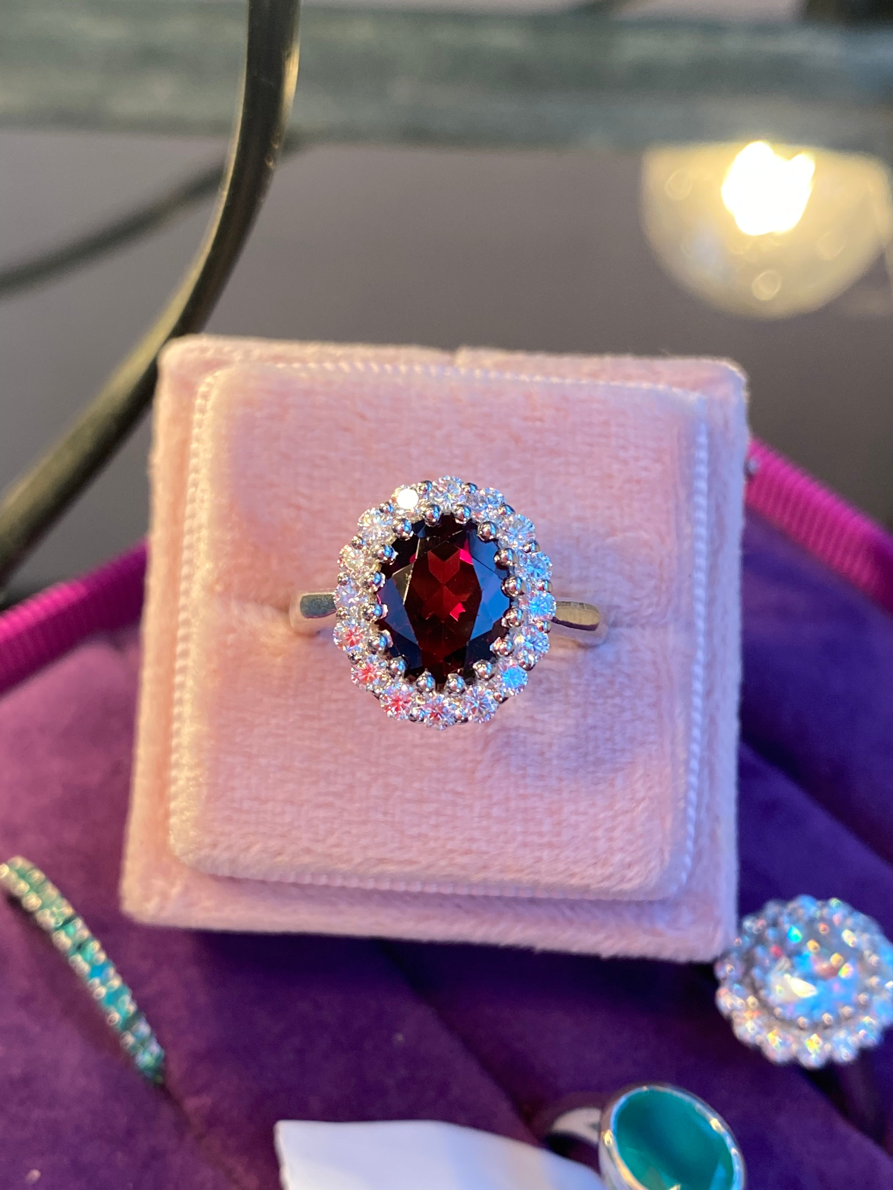 2.33 CTW Oval Cut Garnet and Moissanite Halo Ring in Sterling Silver