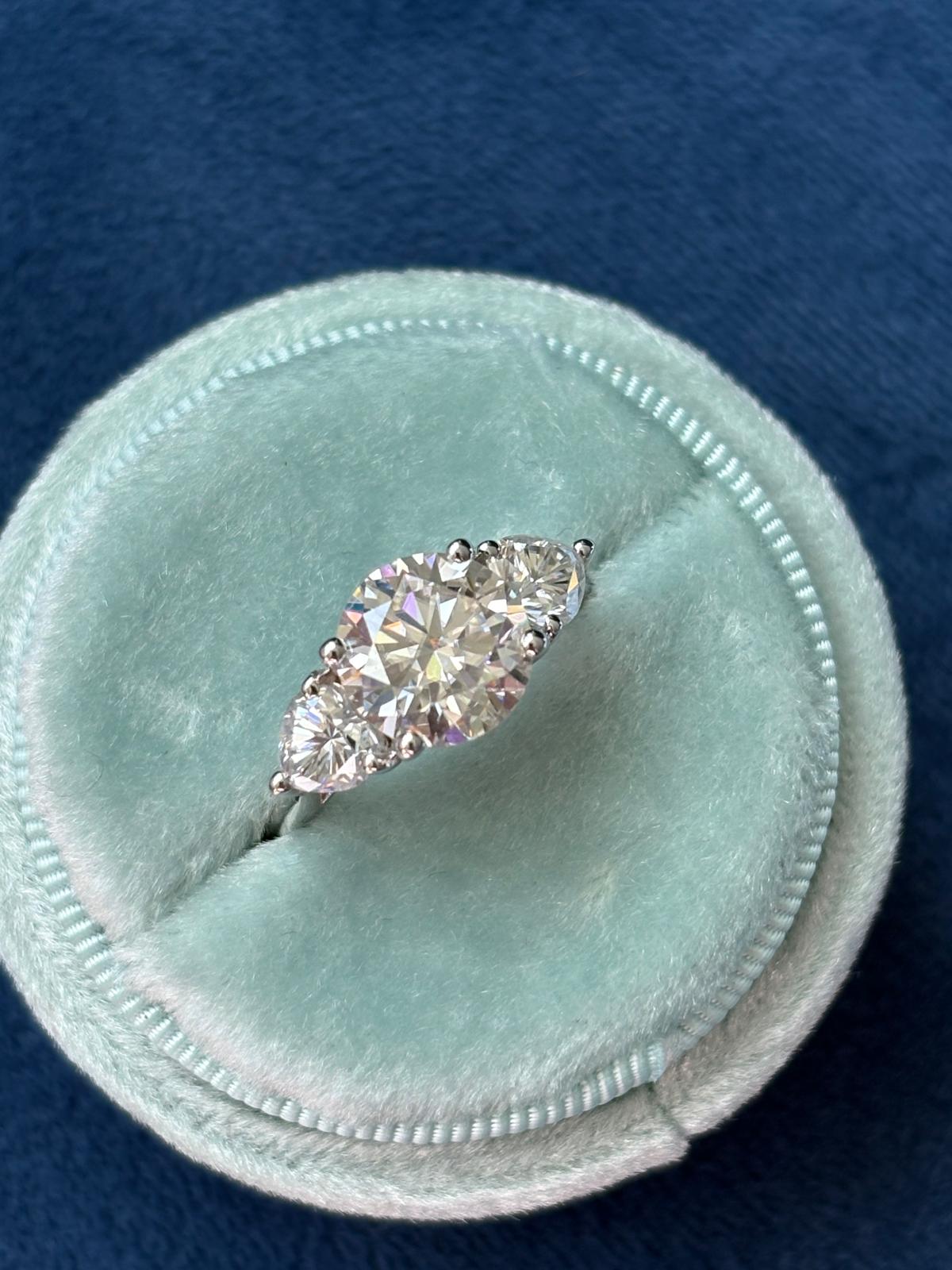 3.40 CTW Round and Heart Shape Moissanite Three Stone Ring in Sterling Silver
