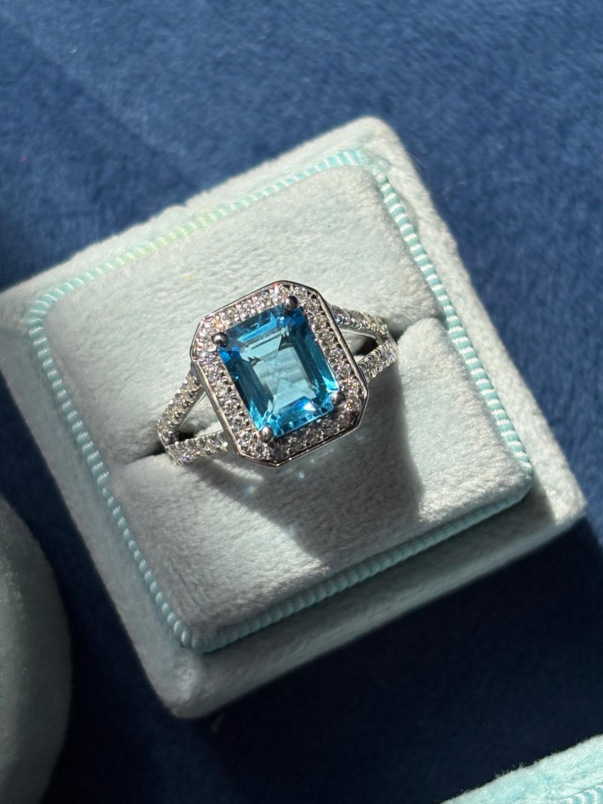 3.10 CTW Emerald Cut Moissanite and Blue Topaz Halo Ring in Sterling Silver