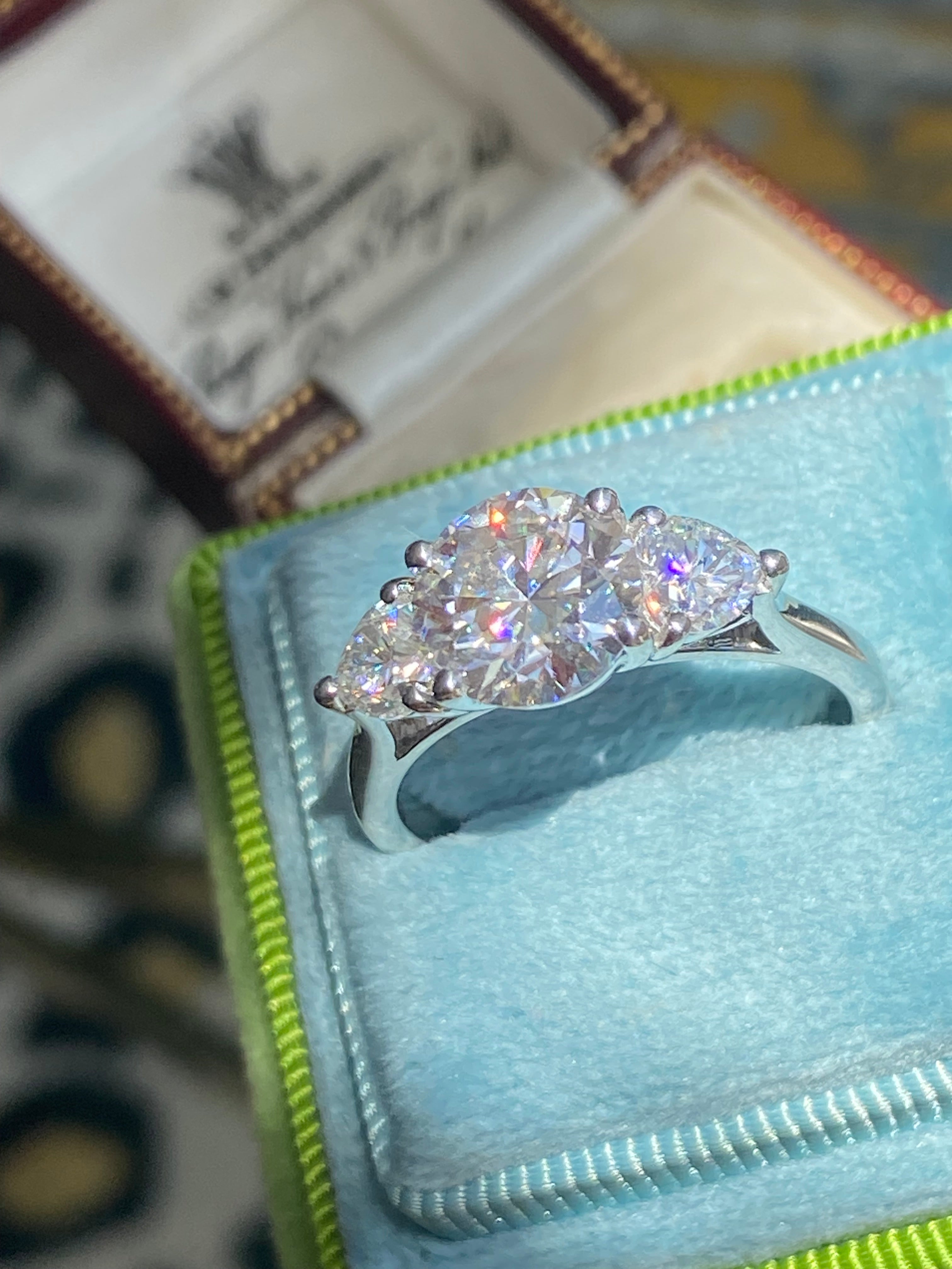 3.40 CTW Round and Heart Shape Moissanite Three Stone Ring in Sterling Silver