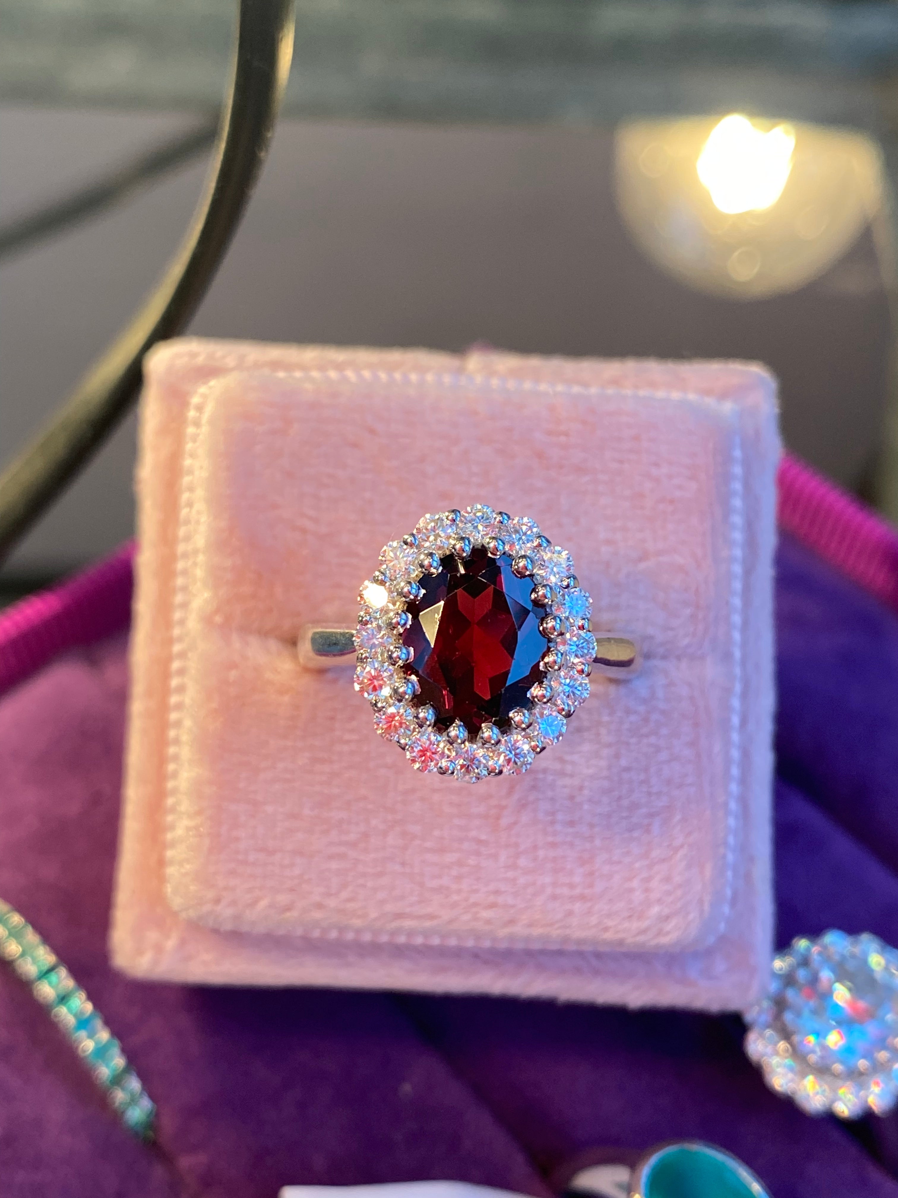 2.33 CTW Oval Cut Garnet and Moissanite Halo Ring in Sterling Silver