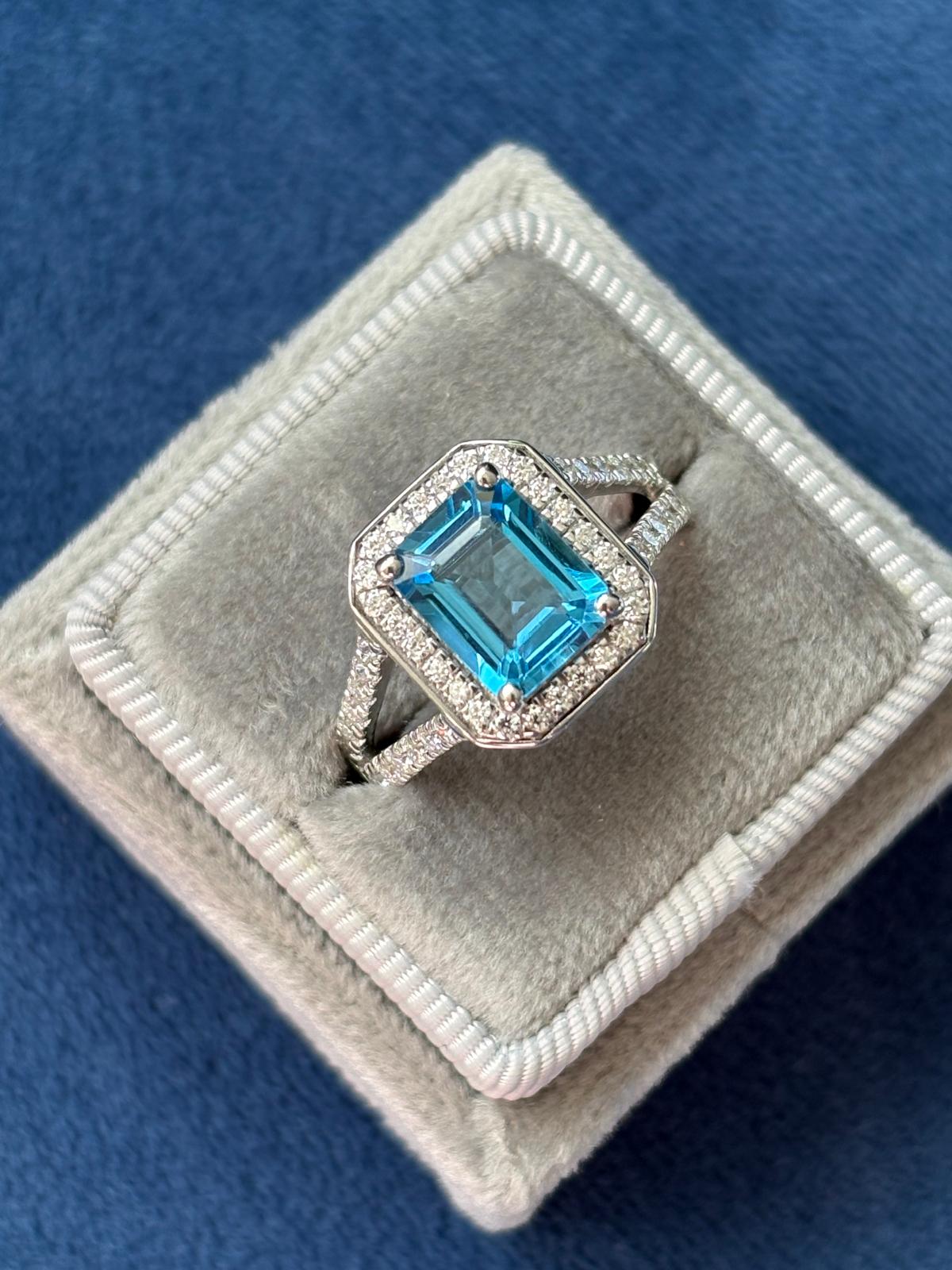 3.10 CTW Emerald Cut Moissanite and Blue Topaz Halo Ring in Sterling Silver