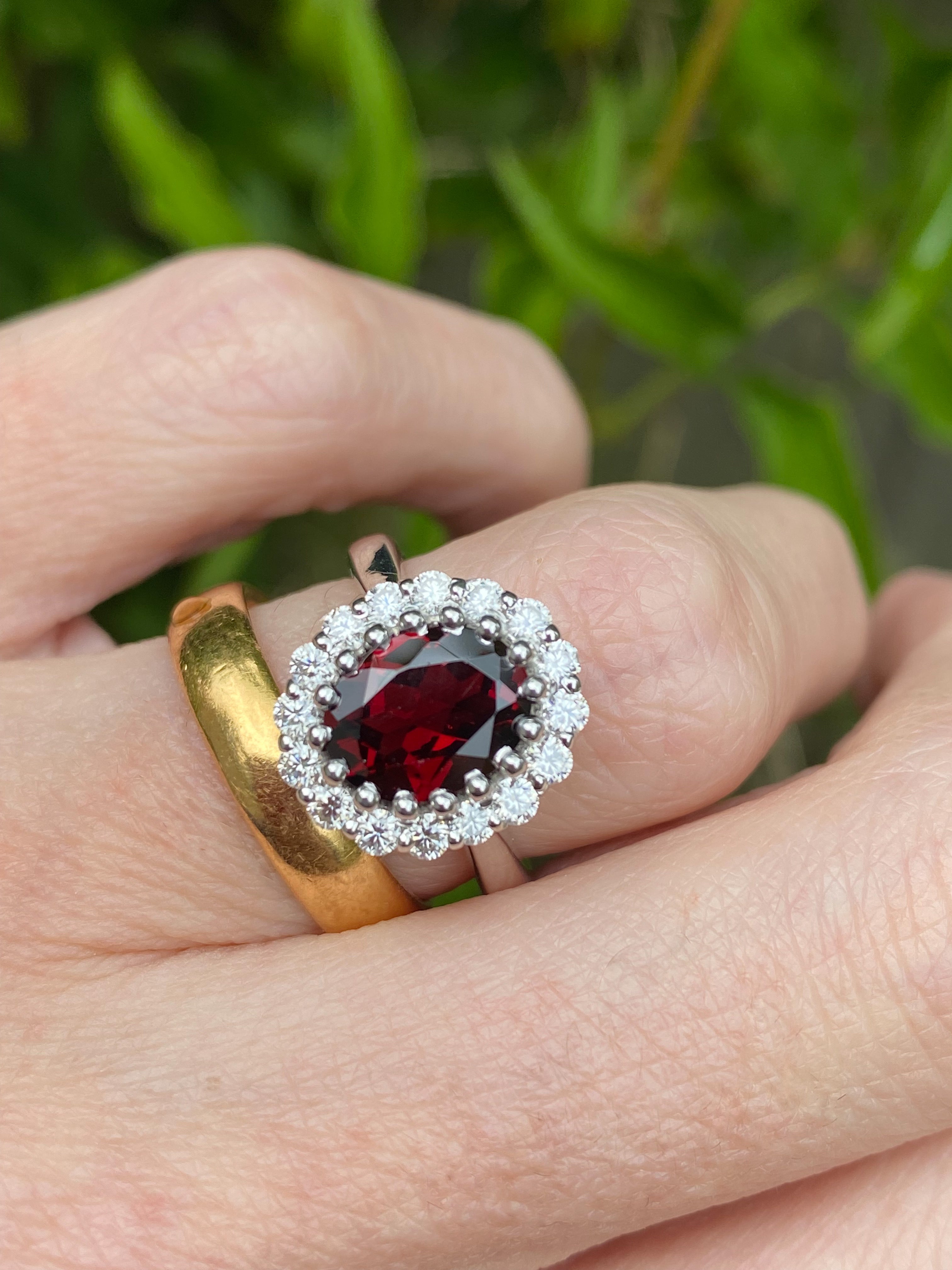 2.33 CTW Oval Cut Garnet and Moissanite Halo Ring in Sterling Silver