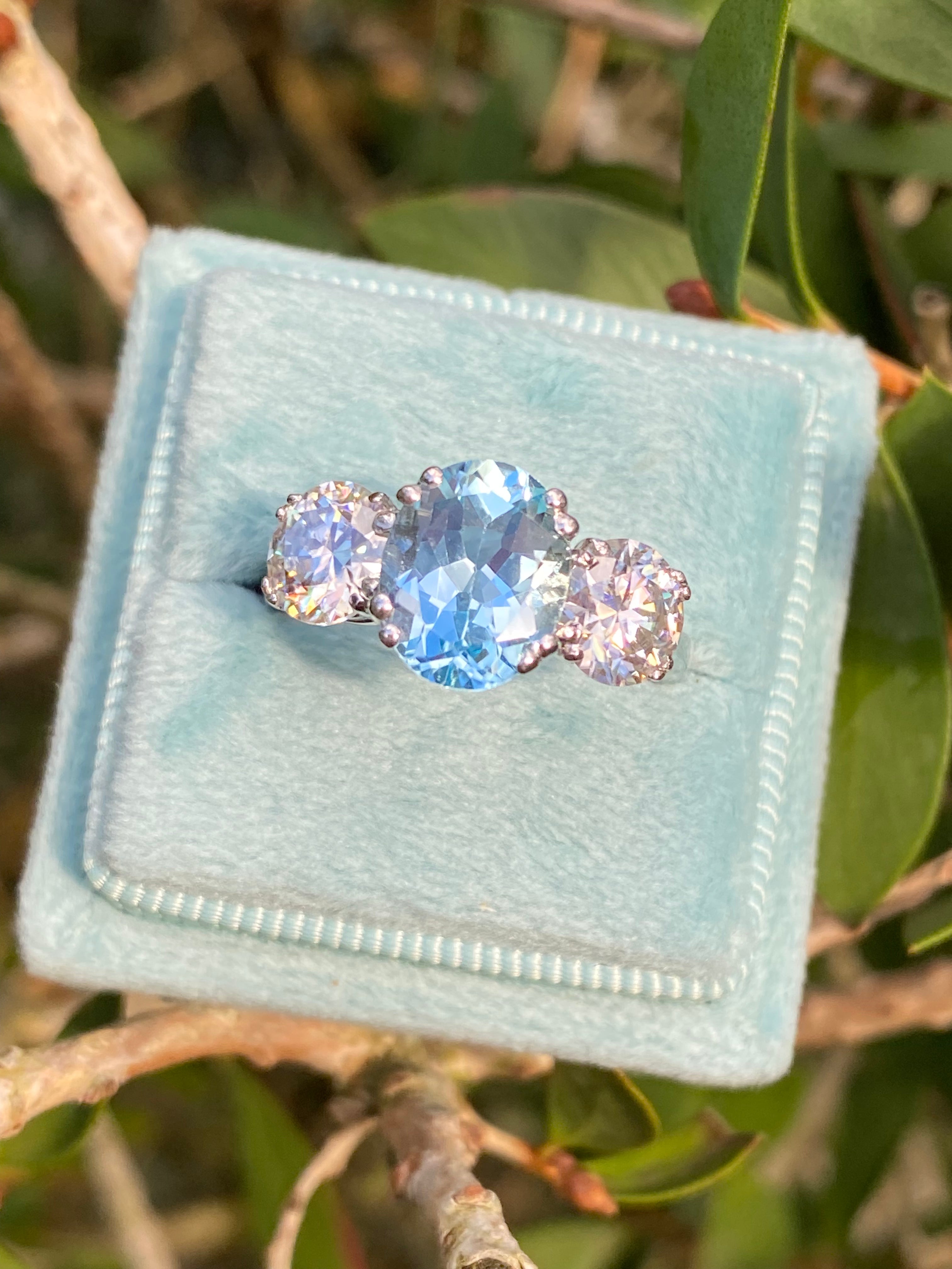 2.57 Carat Blue Topaz and 1.84 Carat Moissanite Three Stone Ring in Sterling Silver