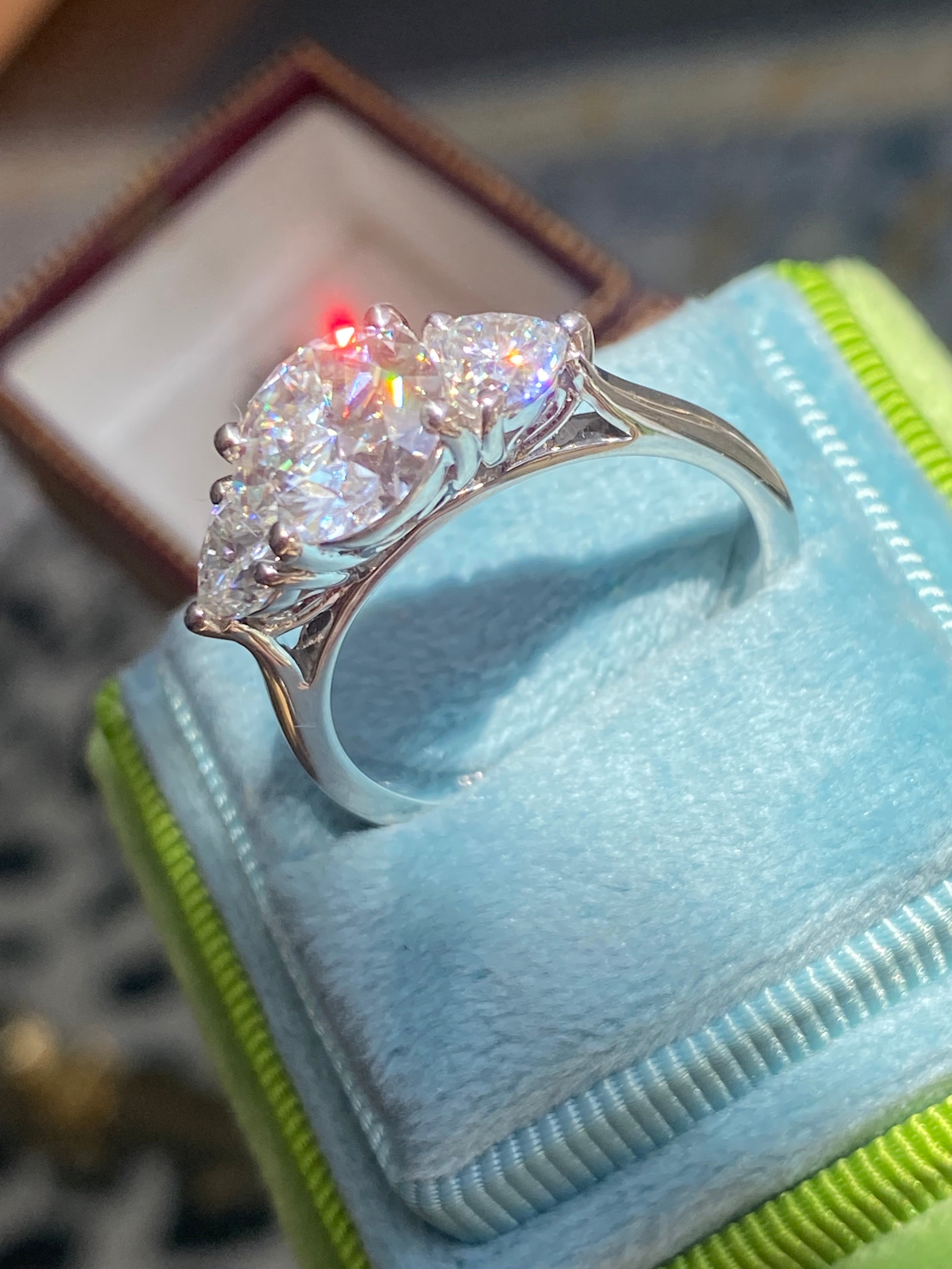 3.40 CTW Round and Heart Shape Moissanite Three Stone Ring in Sterling Silver