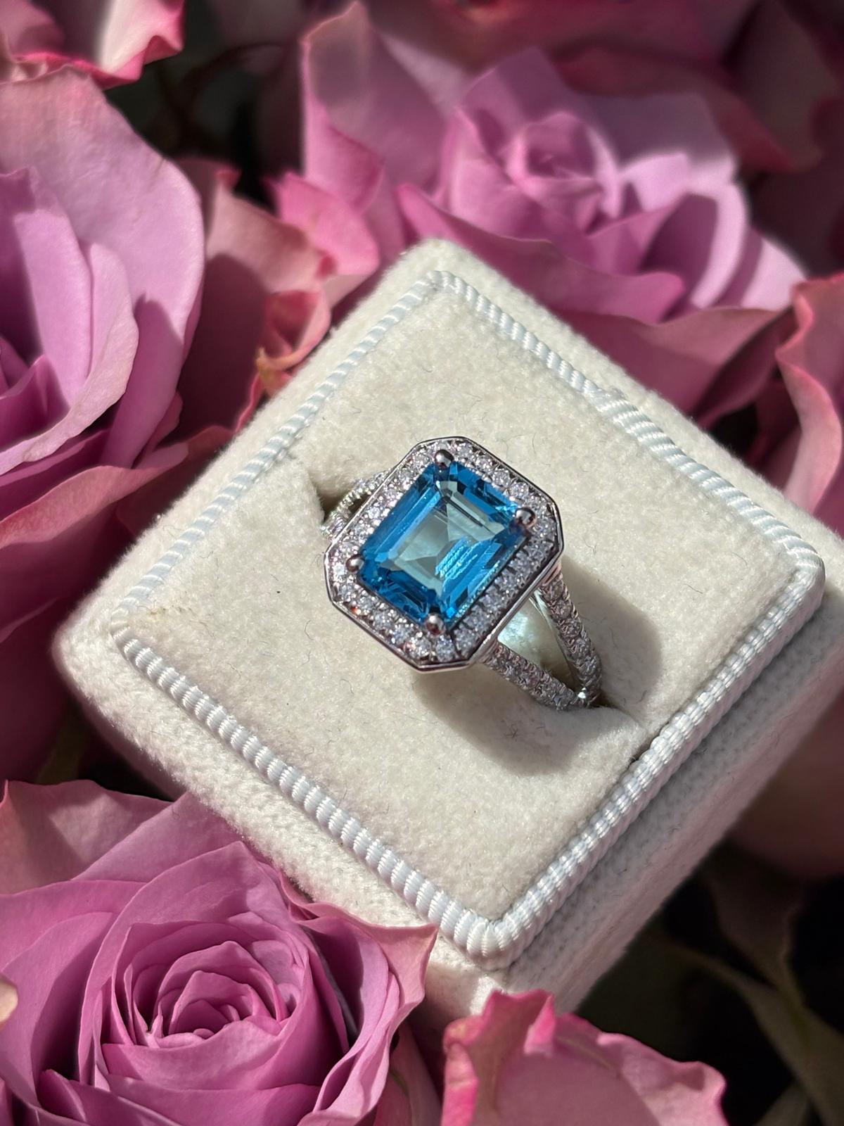 3.10 CTW Emerald Cut Moissanite and Blue Topaz Halo Ring in Sterling Silver