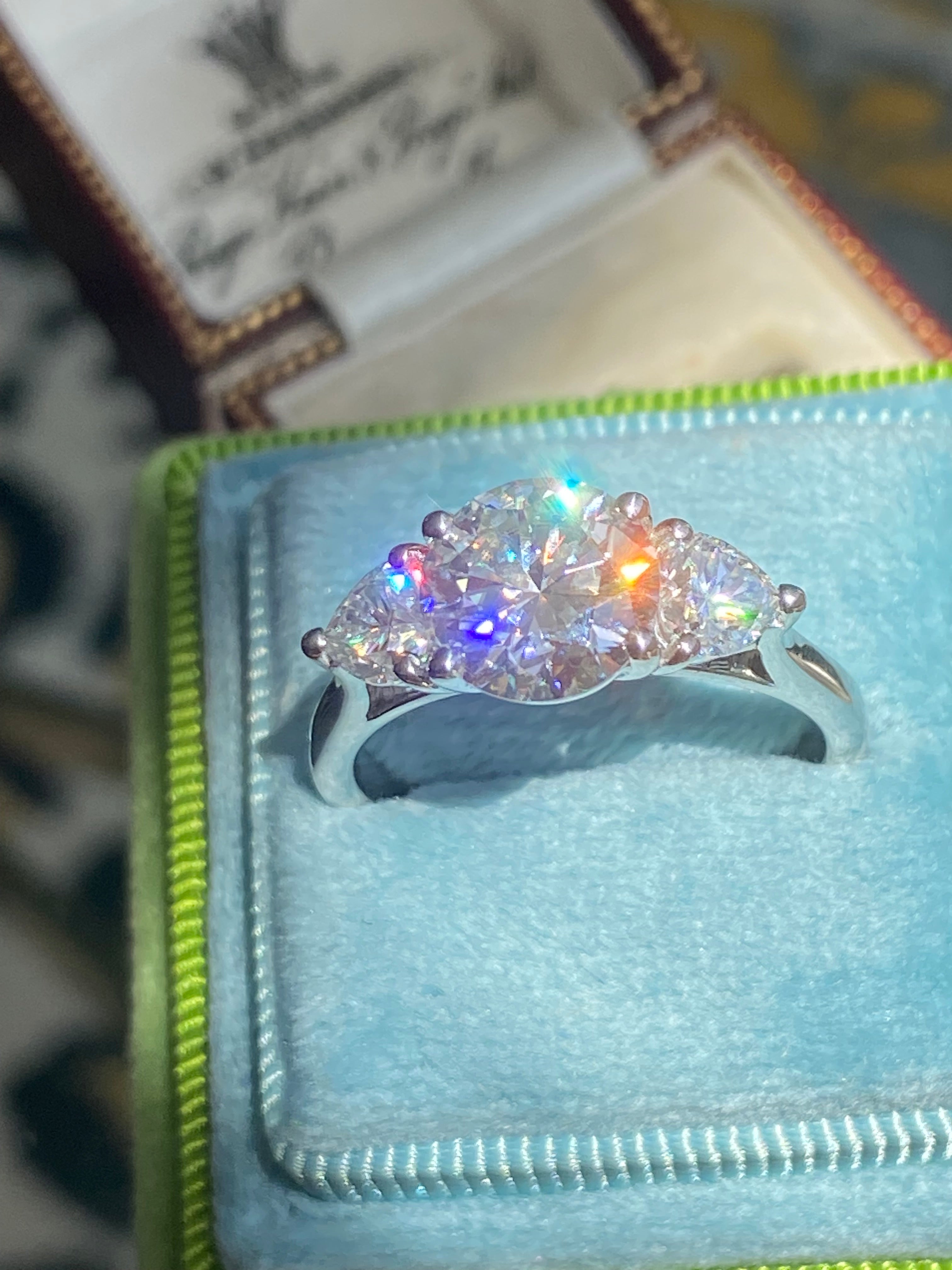 3.40 CTW Round and Heart Shape Moissanite Three Stone Ring in Sterling Silver