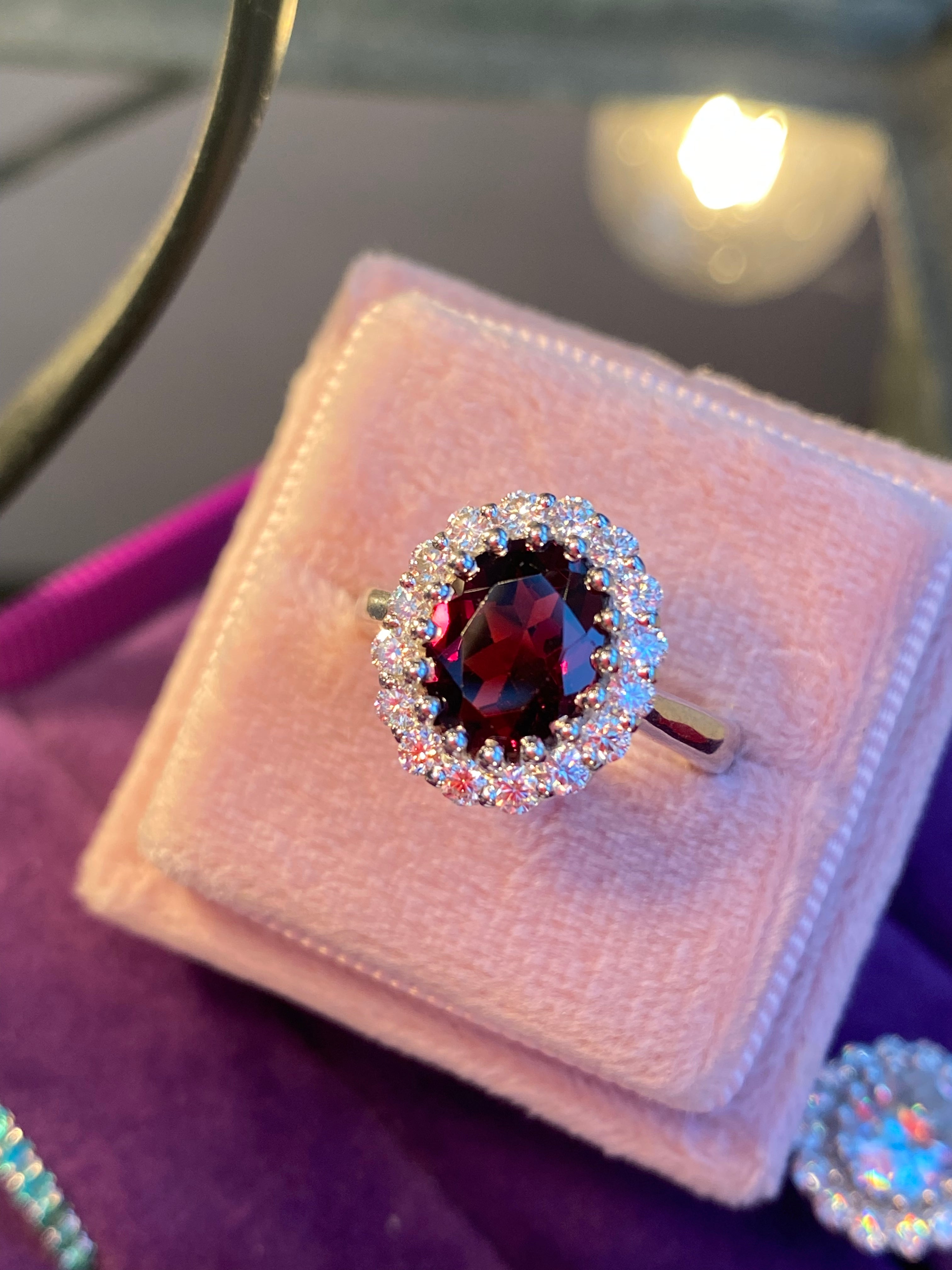 2.33 CTW Oval Cut Garnet and Moissanite Halo Ring in Sterling Silver