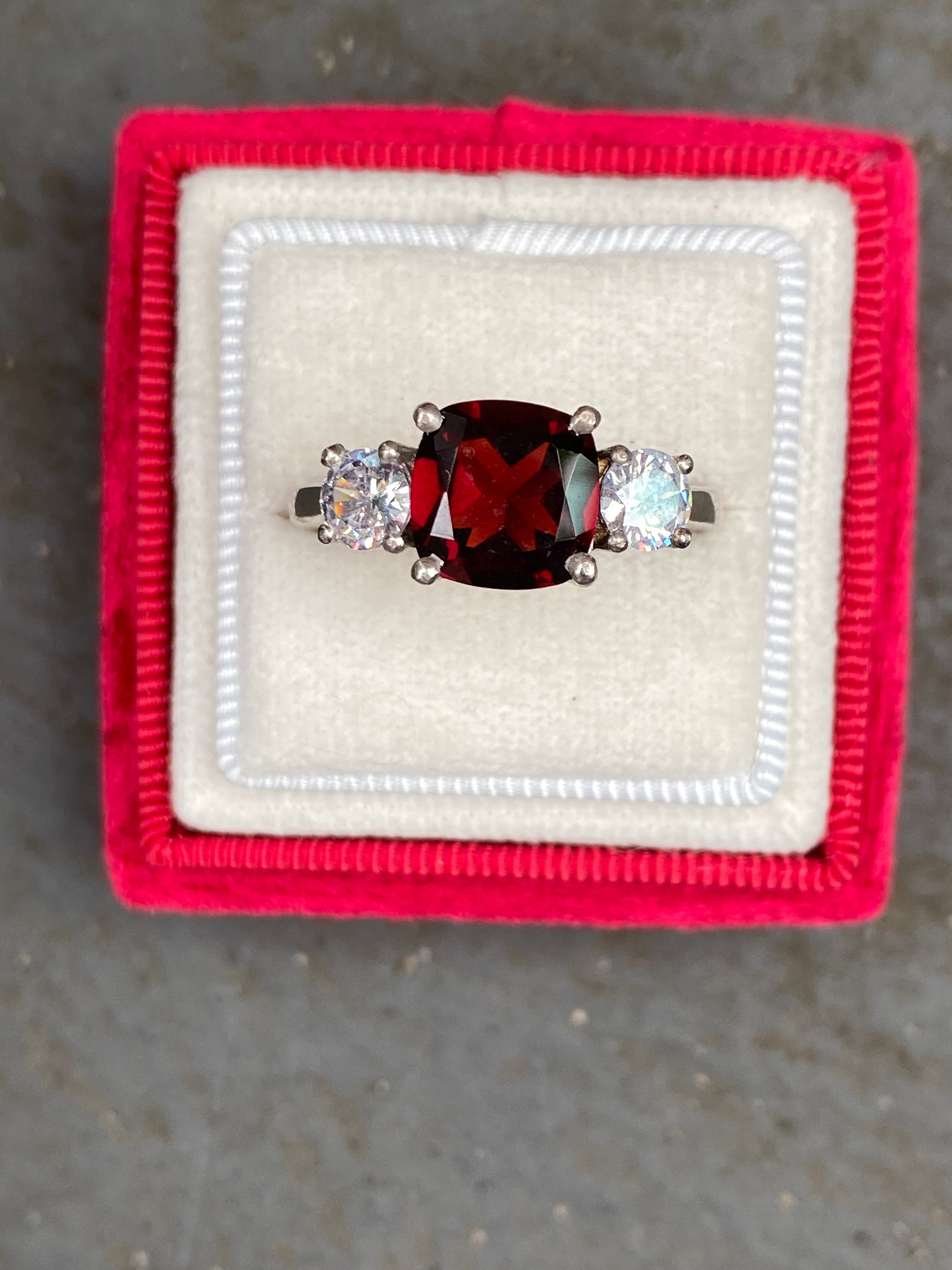 4.00 CTW Cushion Cut Garnet and Moissanite Three Stone Ring in Sterling Silver