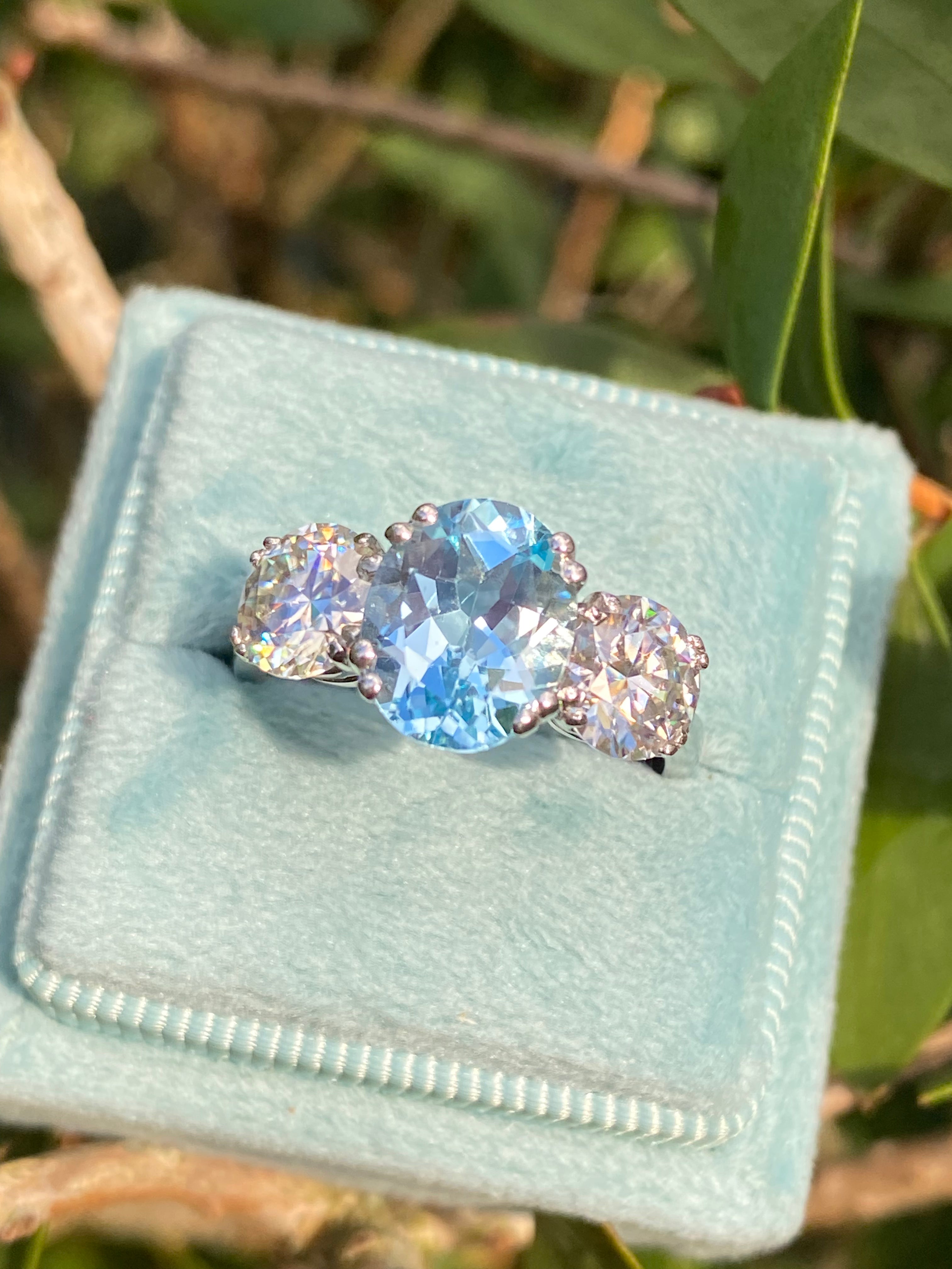 2.57 Carat Blue Topaz and 1.84 Carat Moissanite Three Stone Ring in Sterling Silver