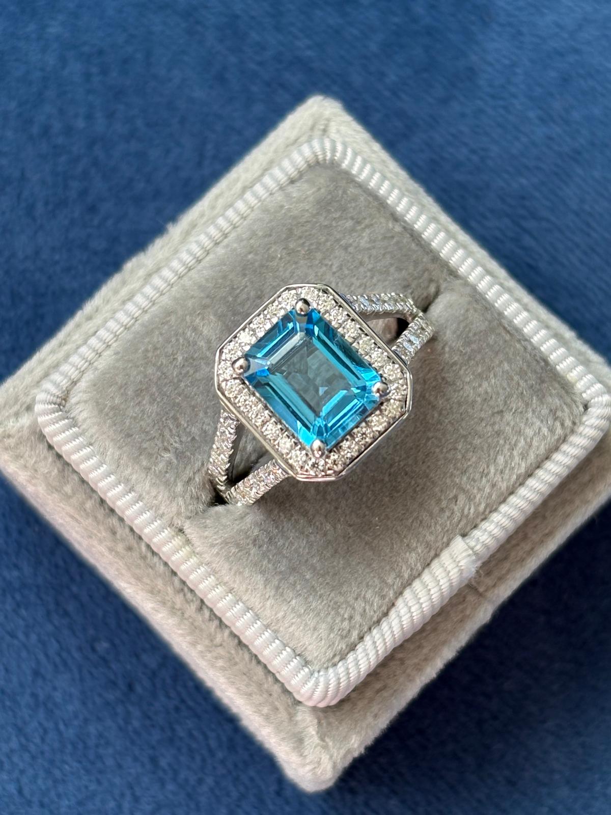 3.10 CTW Emerald Cut Moissanite and Blue Topaz Halo Ring in Sterling Silver