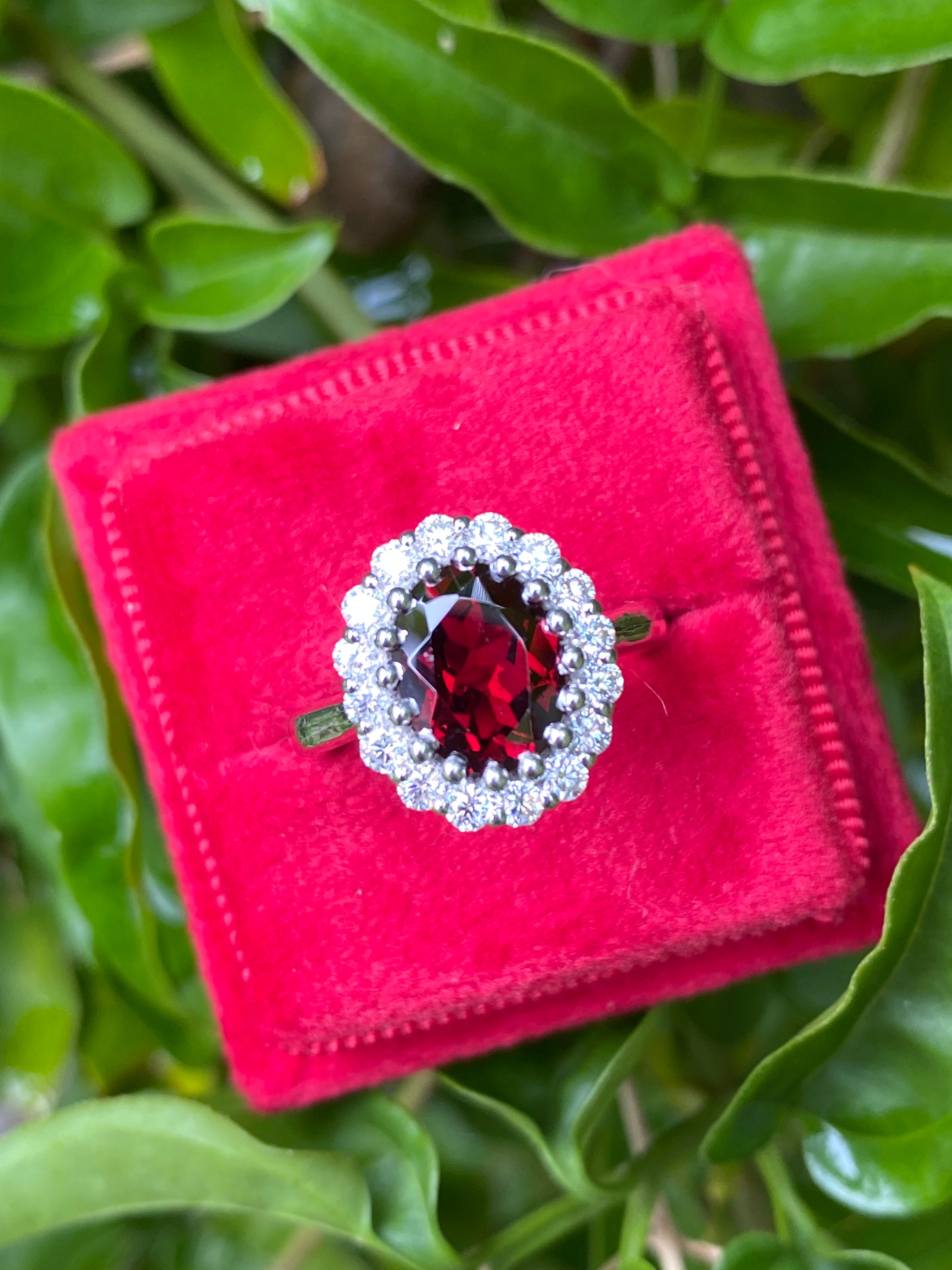 2.33 CTW Oval Cut Garnet and Moissanite Halo Ring in Sterling Silver