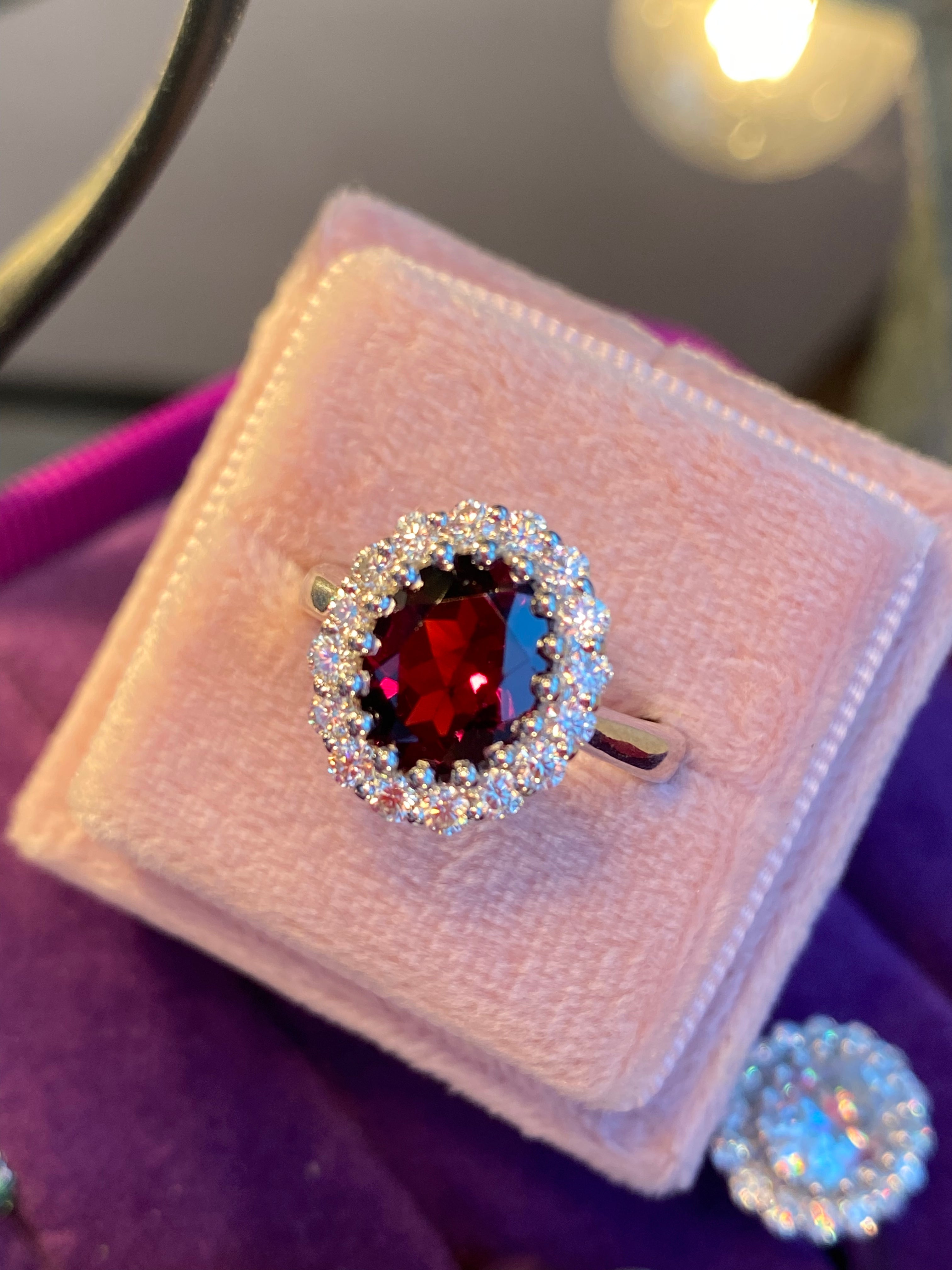 2.33 CTW Oval Cut Garnet and Moissanite Halo Ring in Sterling Silver