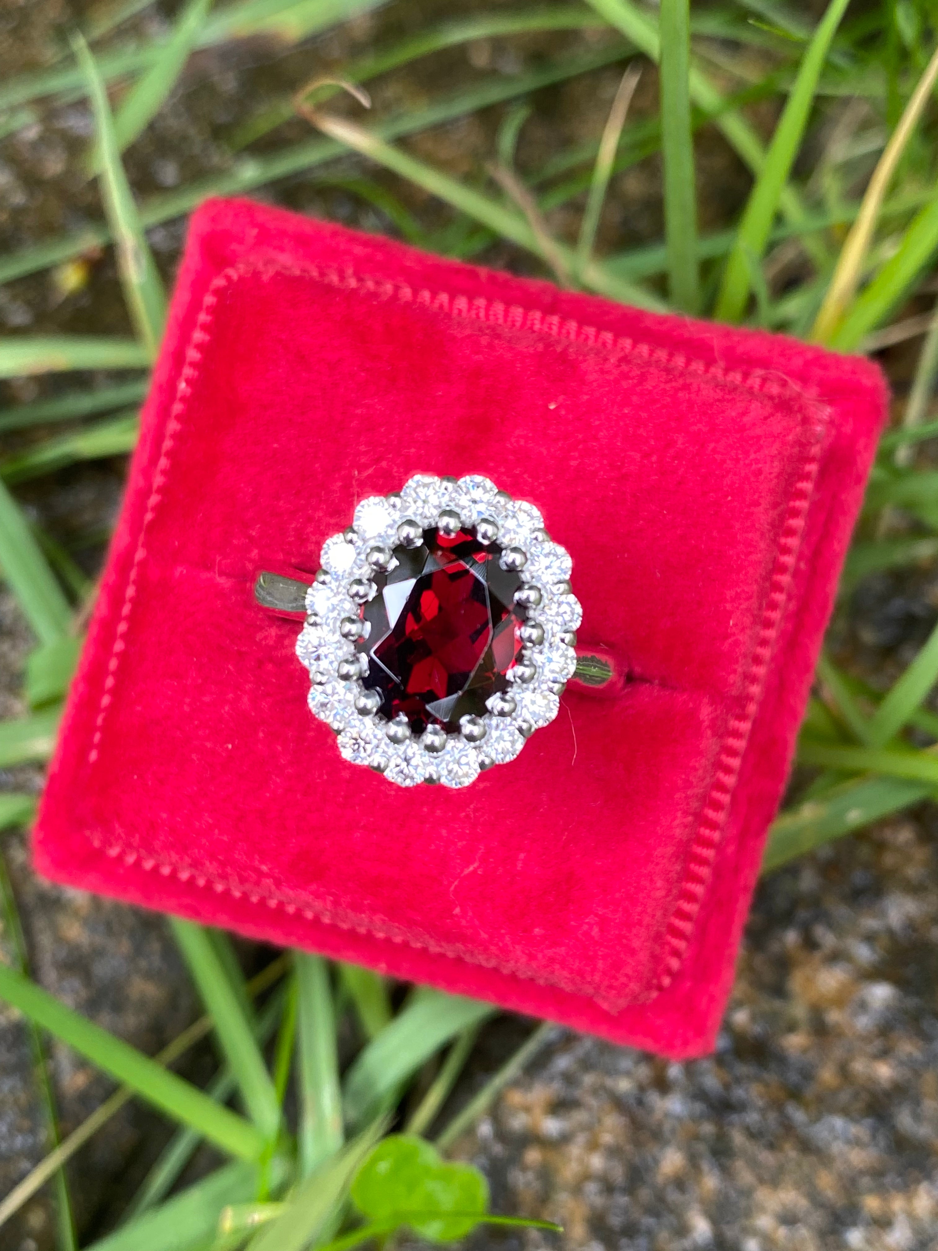 2.33 CTW Oval Cut Garnet and Moissanite Halo Ring in Sterling Silver