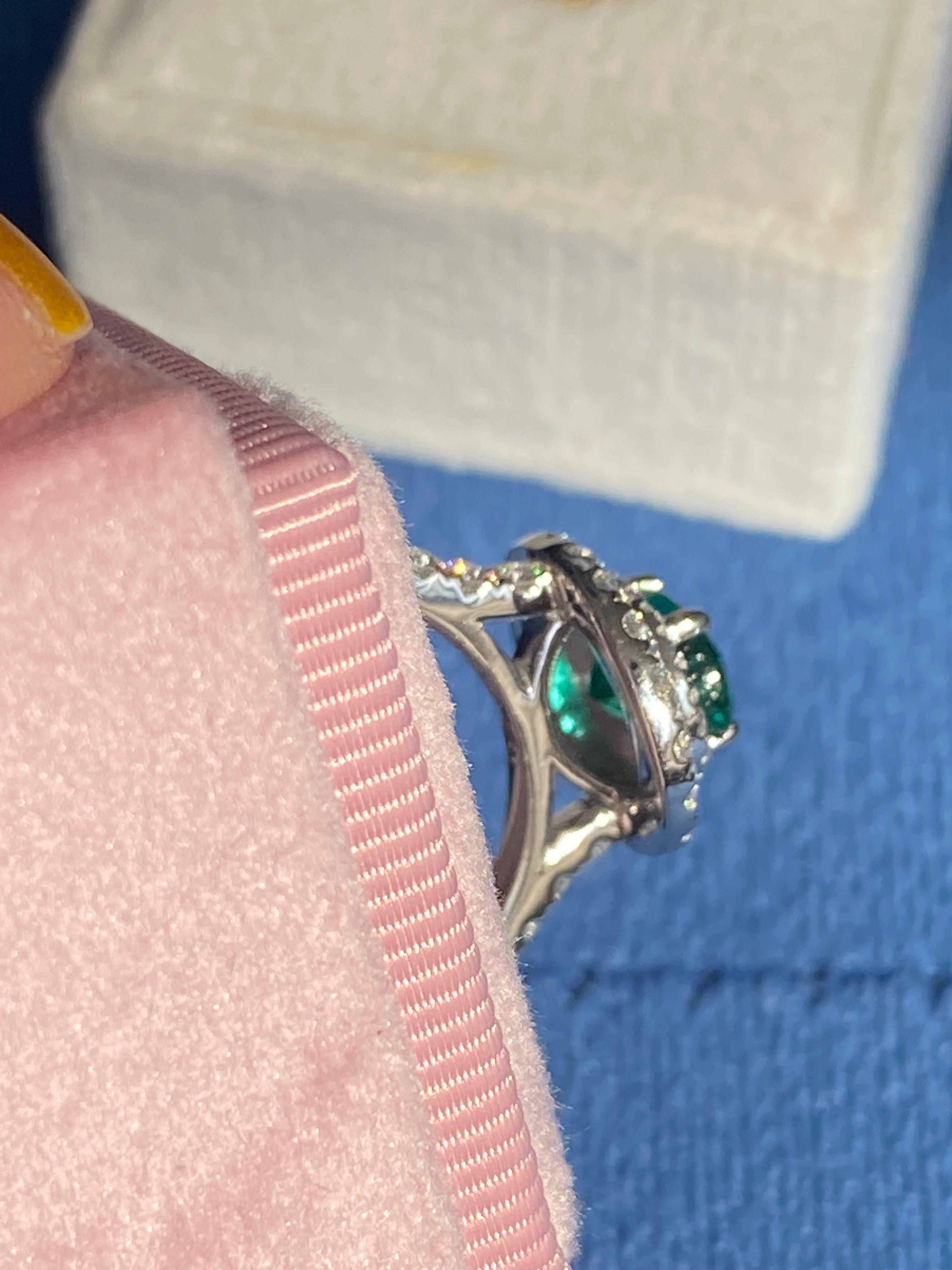 2.11 CTW Oval Cut Emerald and Natural Diamond Double Halo Ring in Platinum