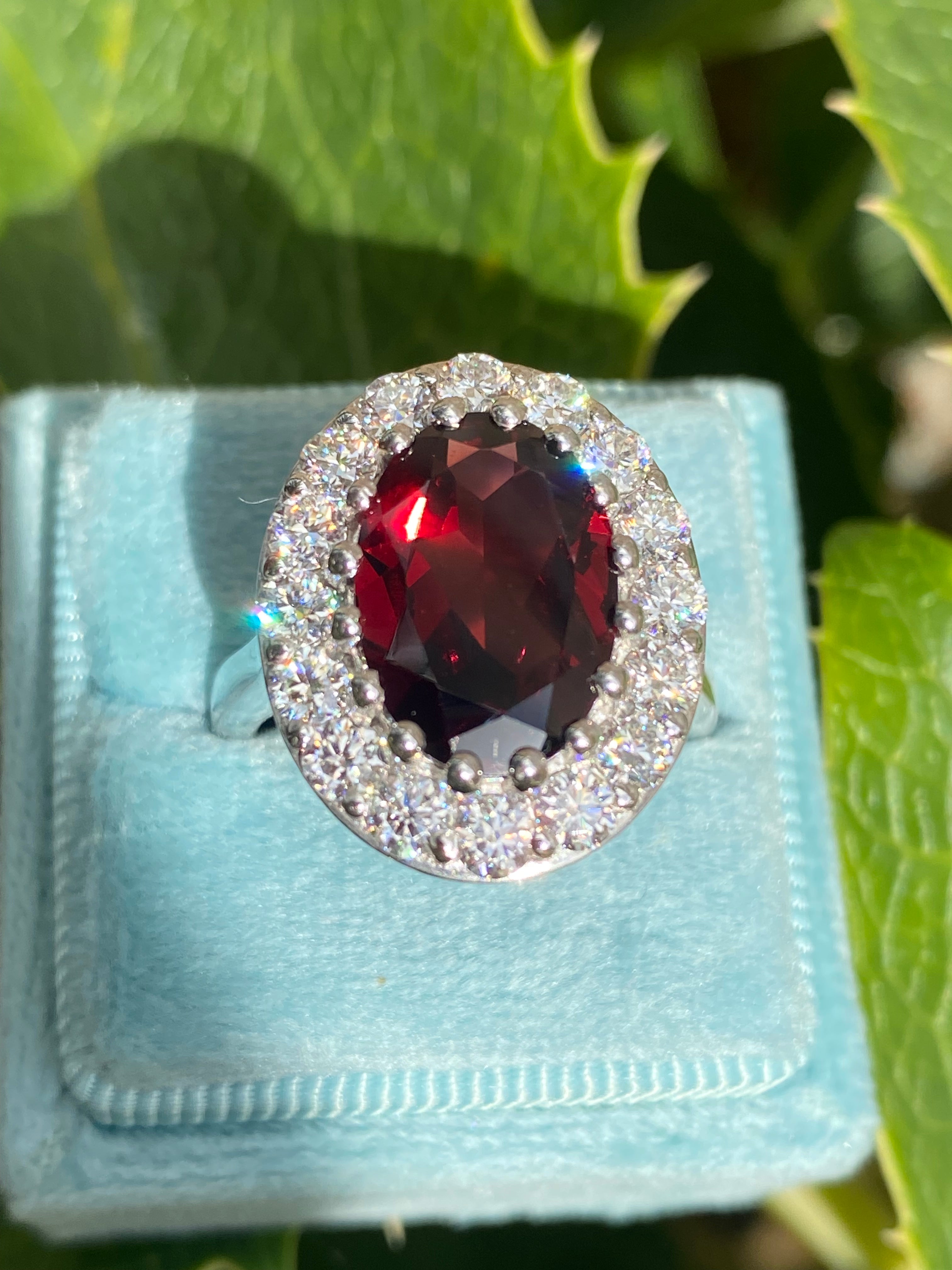 8.25 CTW Oval Cut Garnet and Moissanite Halo Cocktail Ring in Sterling Silver