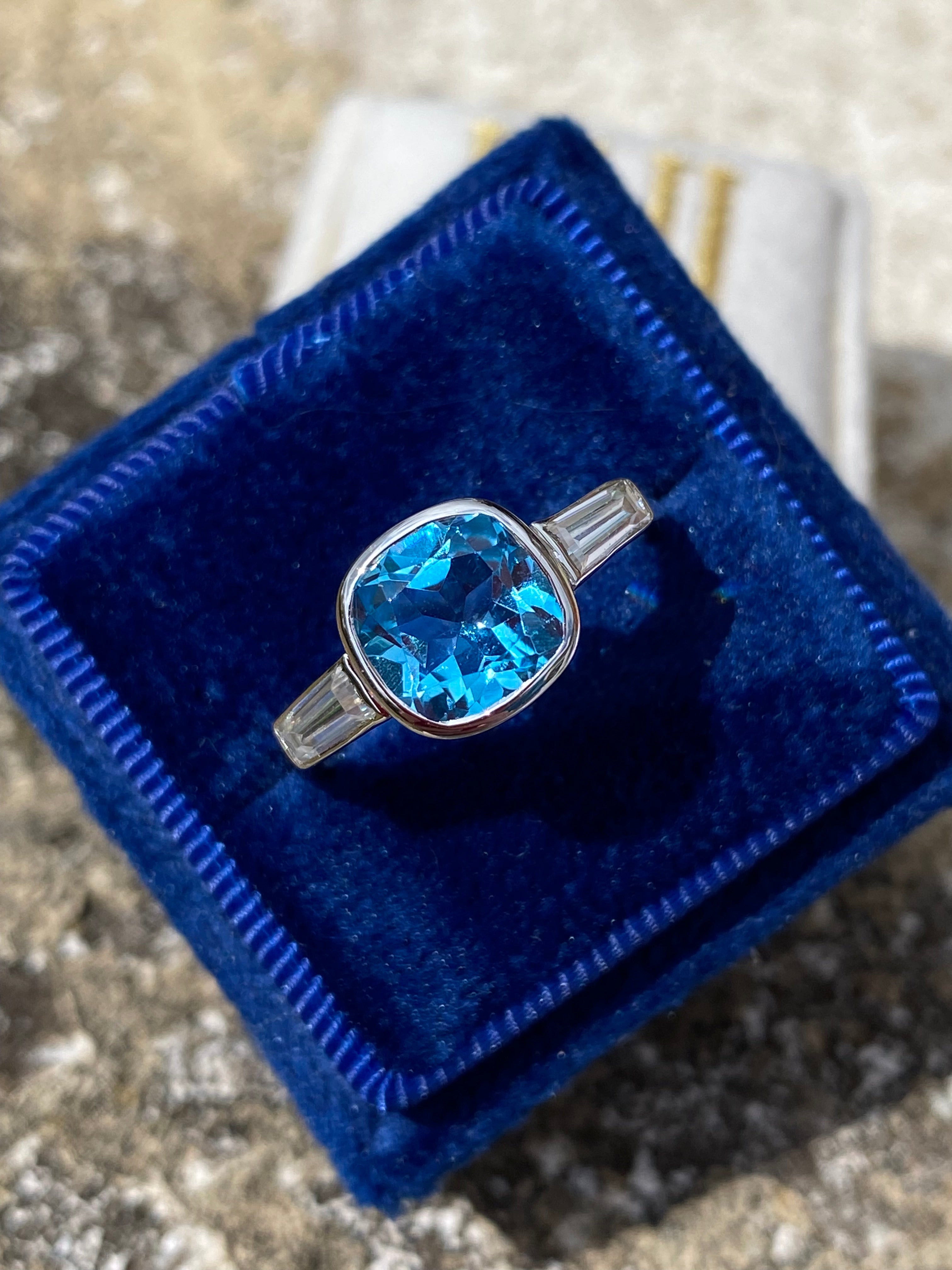 2.33 Carat Cushion Cut Blue Topaz and Moissanite Three Stone Ring in Sterling Silver
