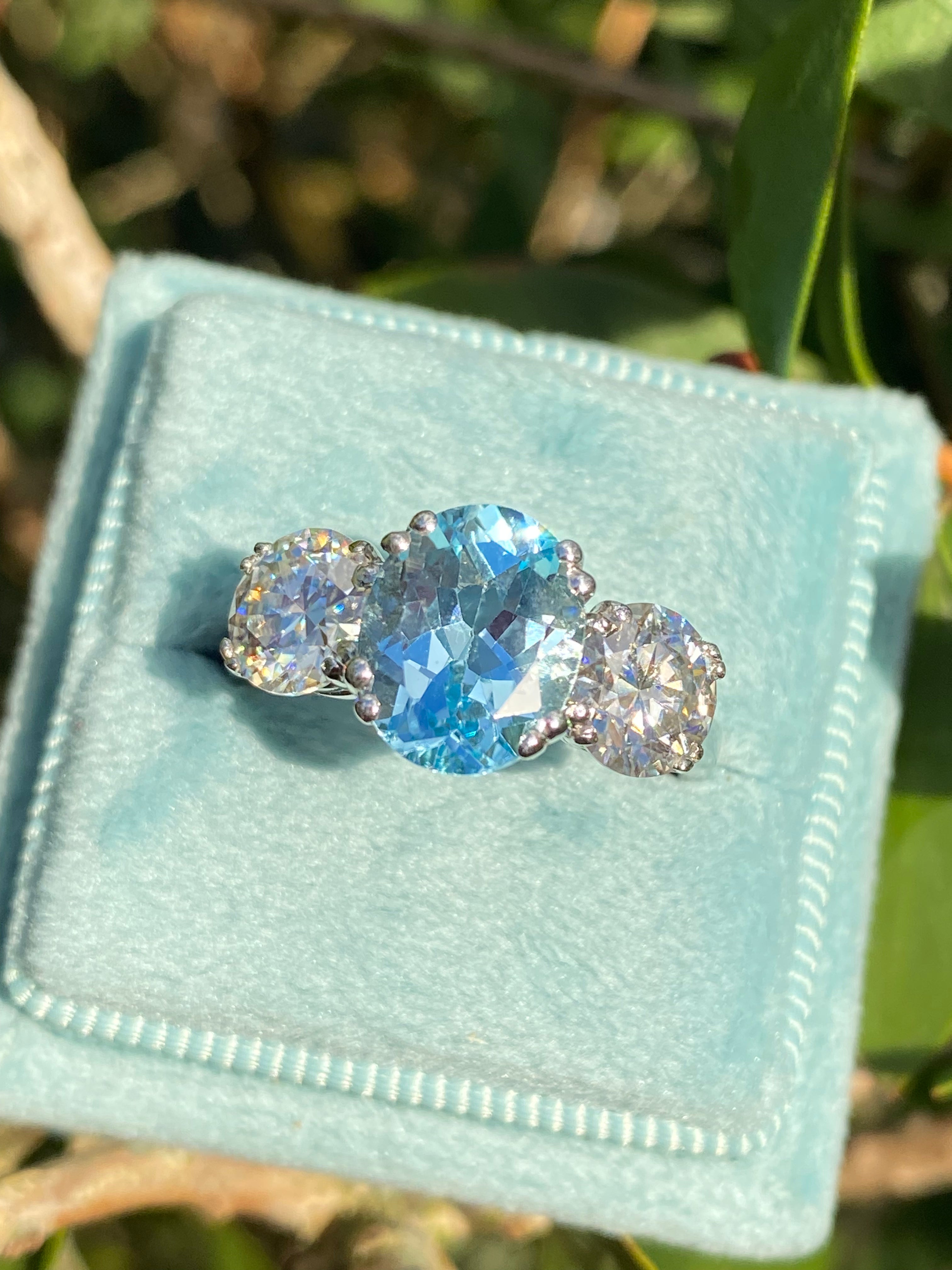 2.57 Carat Blue Topaz and 1.84 Carat Moissanite Three Stone Ring in Sterling Silver
