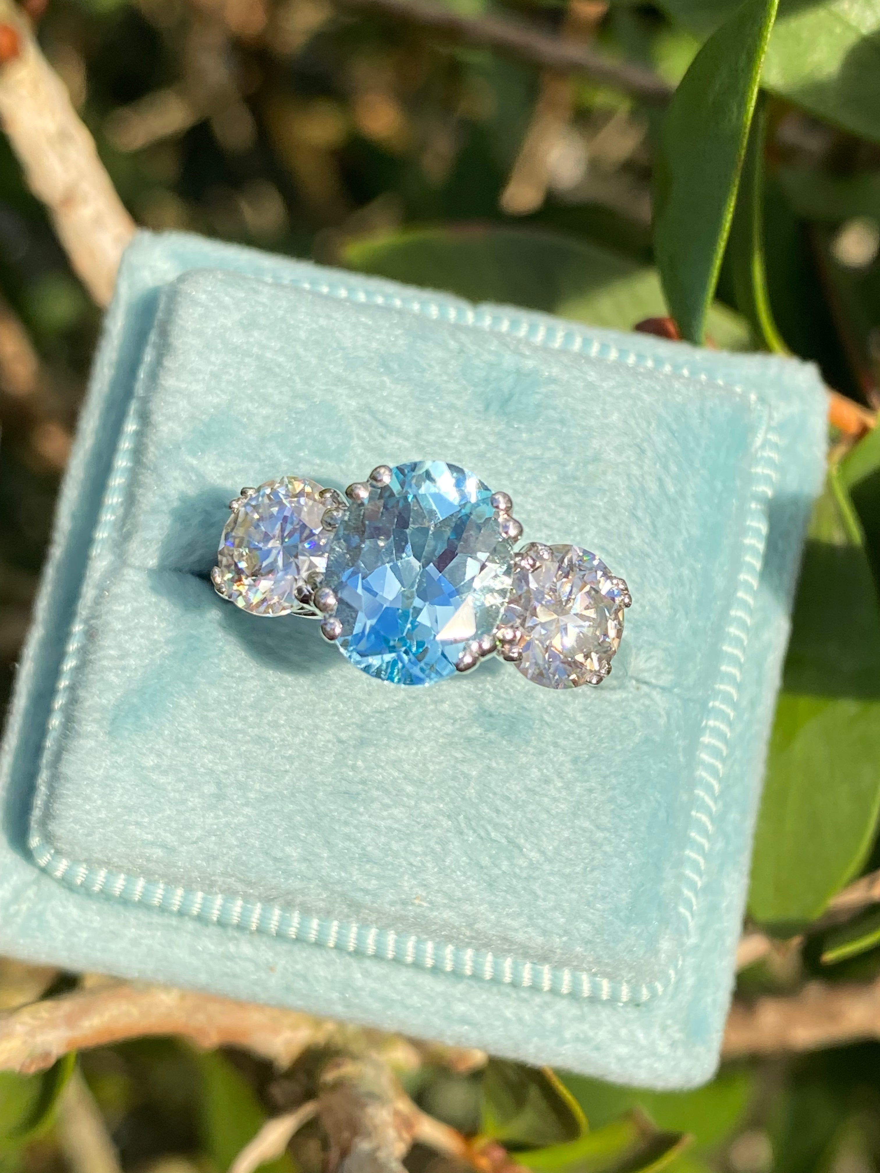 2.57 Carat Blue Topaz and 1.84 Carat Moissanite Three Stone Ring in Sterling Silver