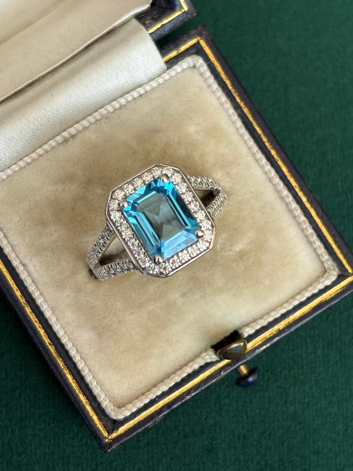 3.10 CTW Emerald Cut Moissanite and Blue Topaz Halo Ring in Sterling Silver