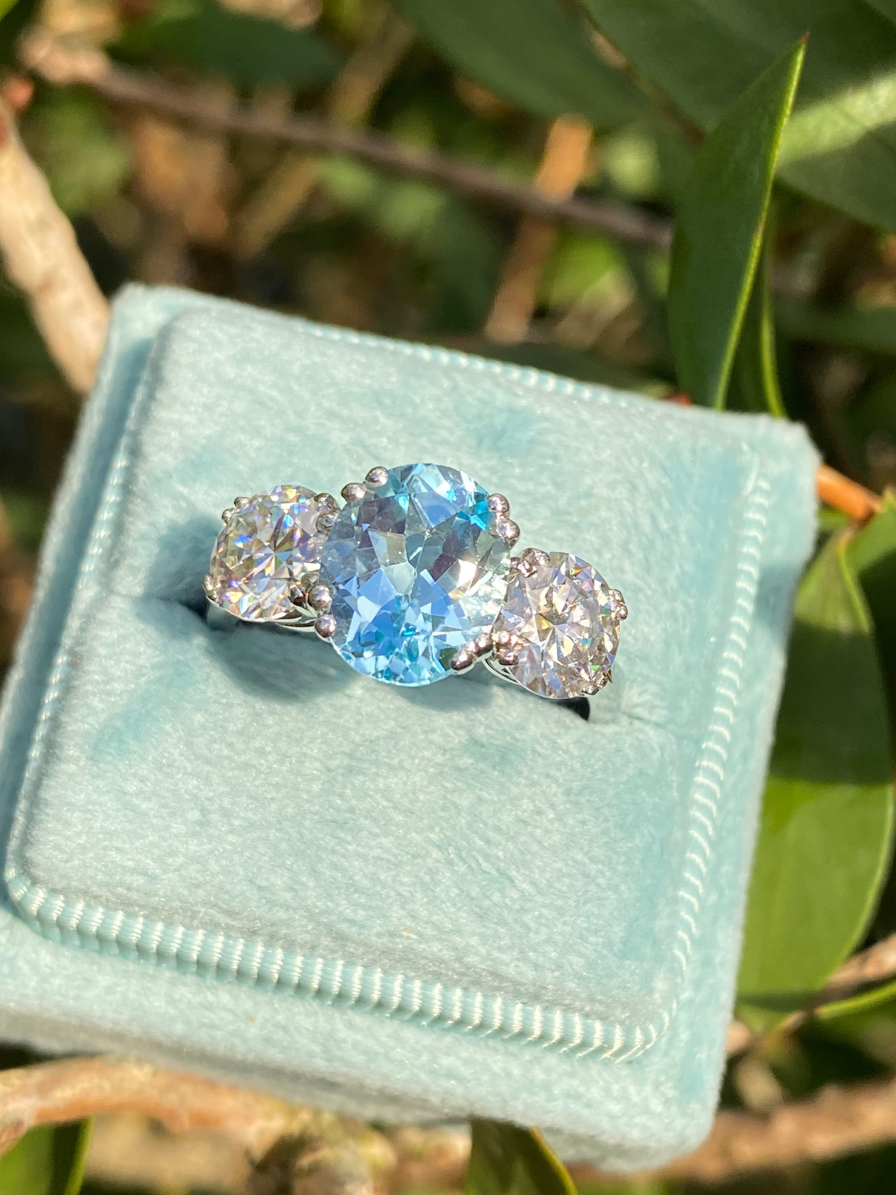 2.57 Carat Blue Topaz and 1.84 Carat Moissanite Three Stone Ring in Sterling Silver