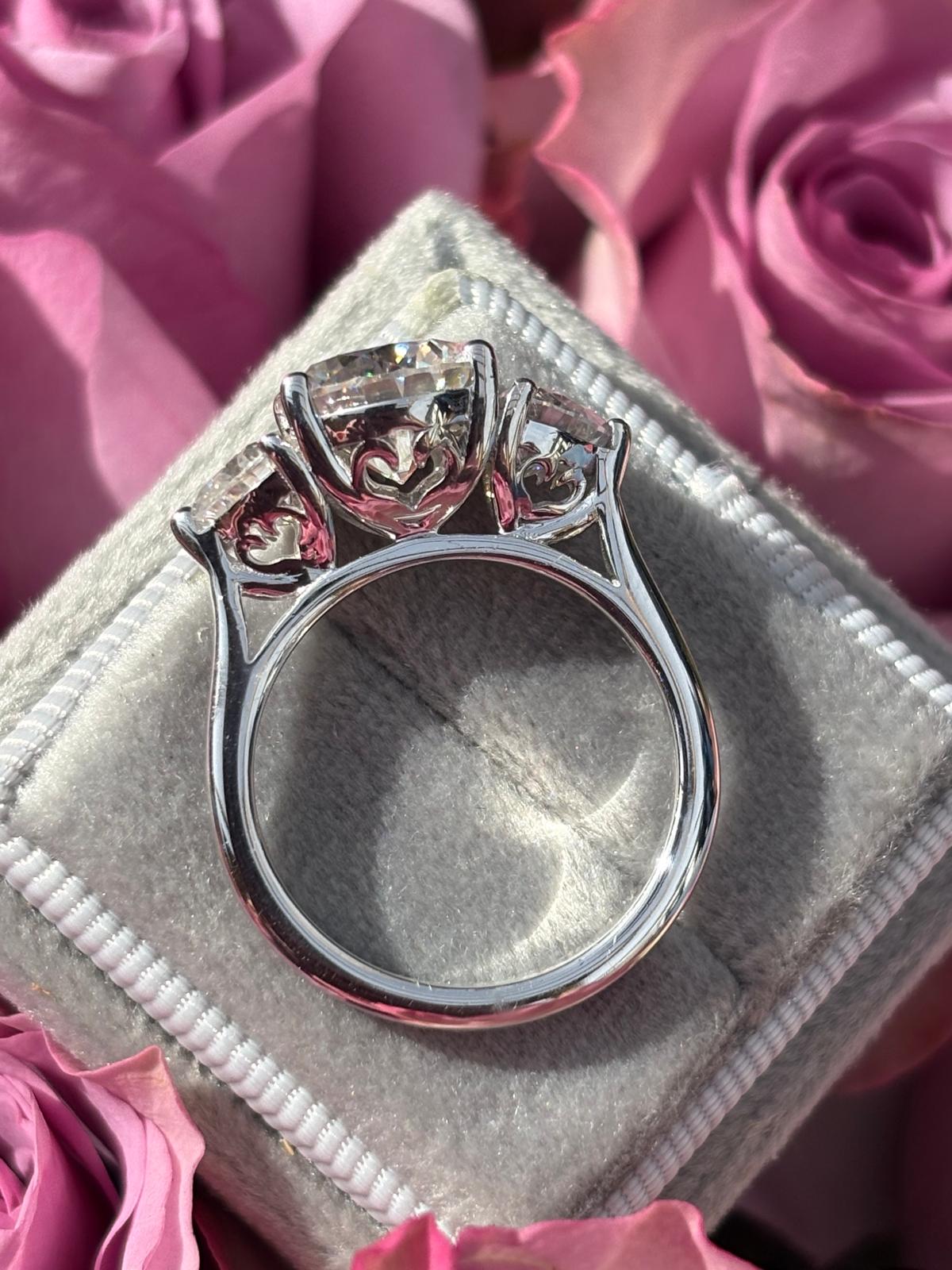 3.40 CTW Round and Heart Shape Moissanite Three Stone Ring in Sterling Silver