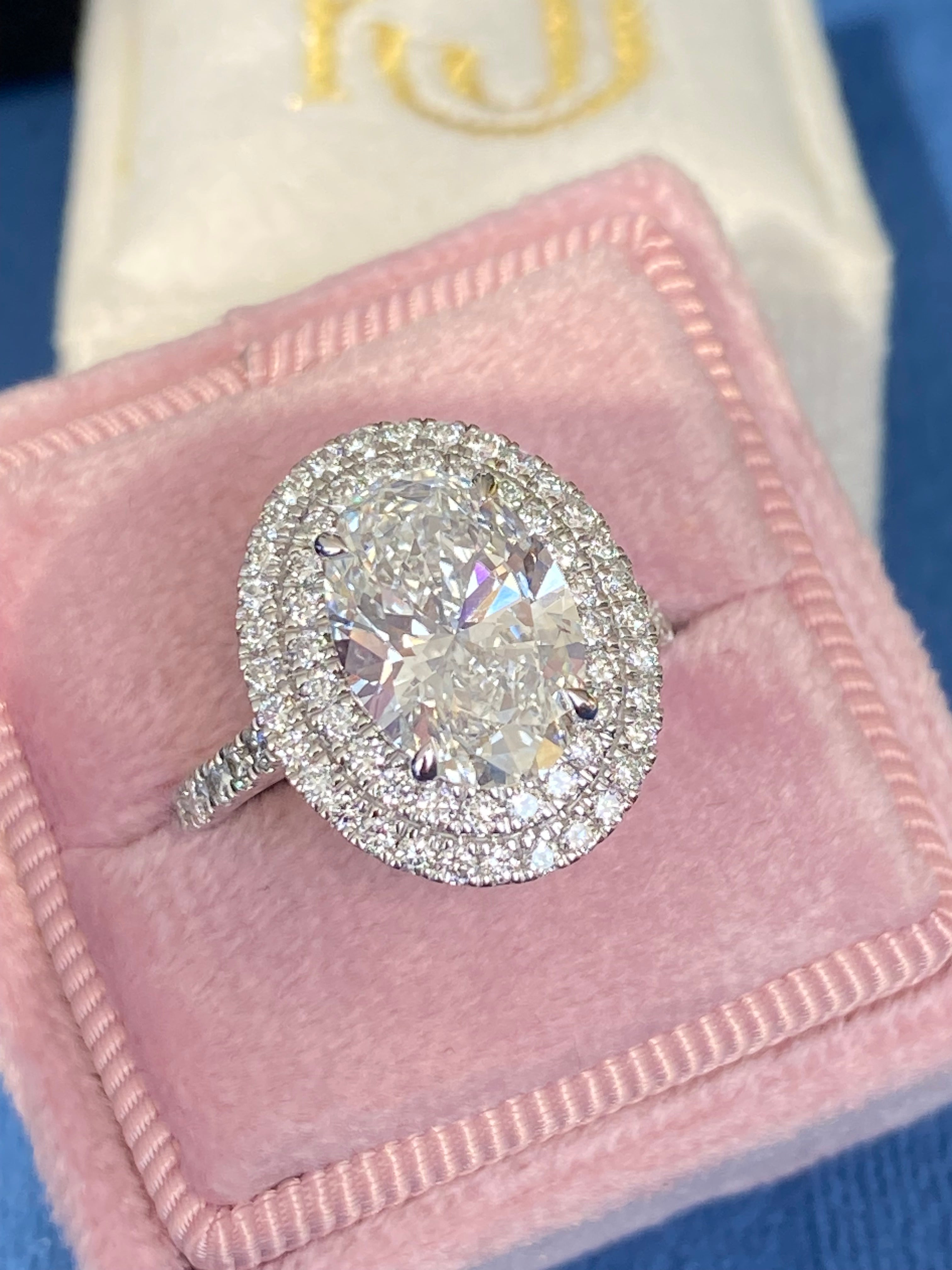 3.92 CTW Oval Cut Lab Diamond Double Halo Engagement Ring in Platinum