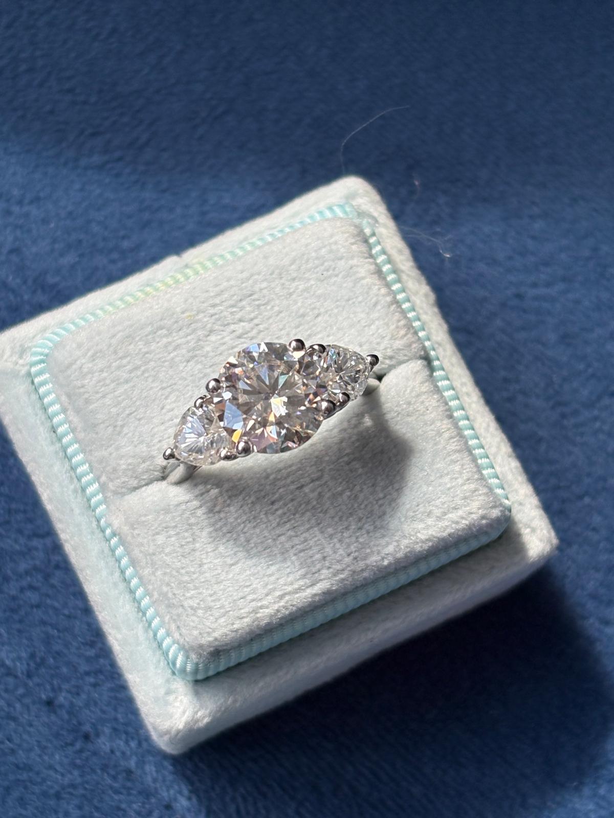3.40 CTW Round and Heart Shape Moissanite Three Stone Ring in Sterling Silver