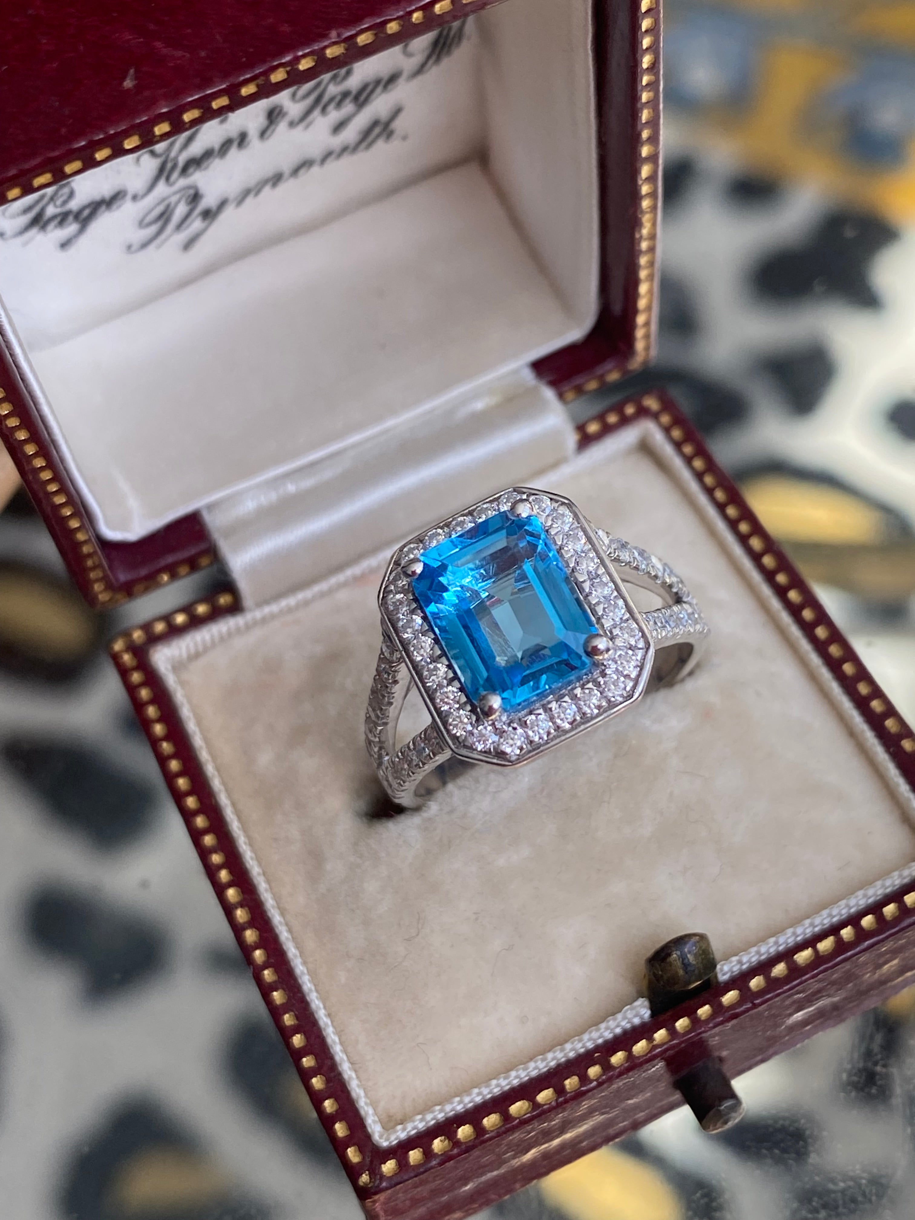 3.10 CTW Emerald Cut Moissanite and Blue Topaz Halo Ring in Sterling Silver