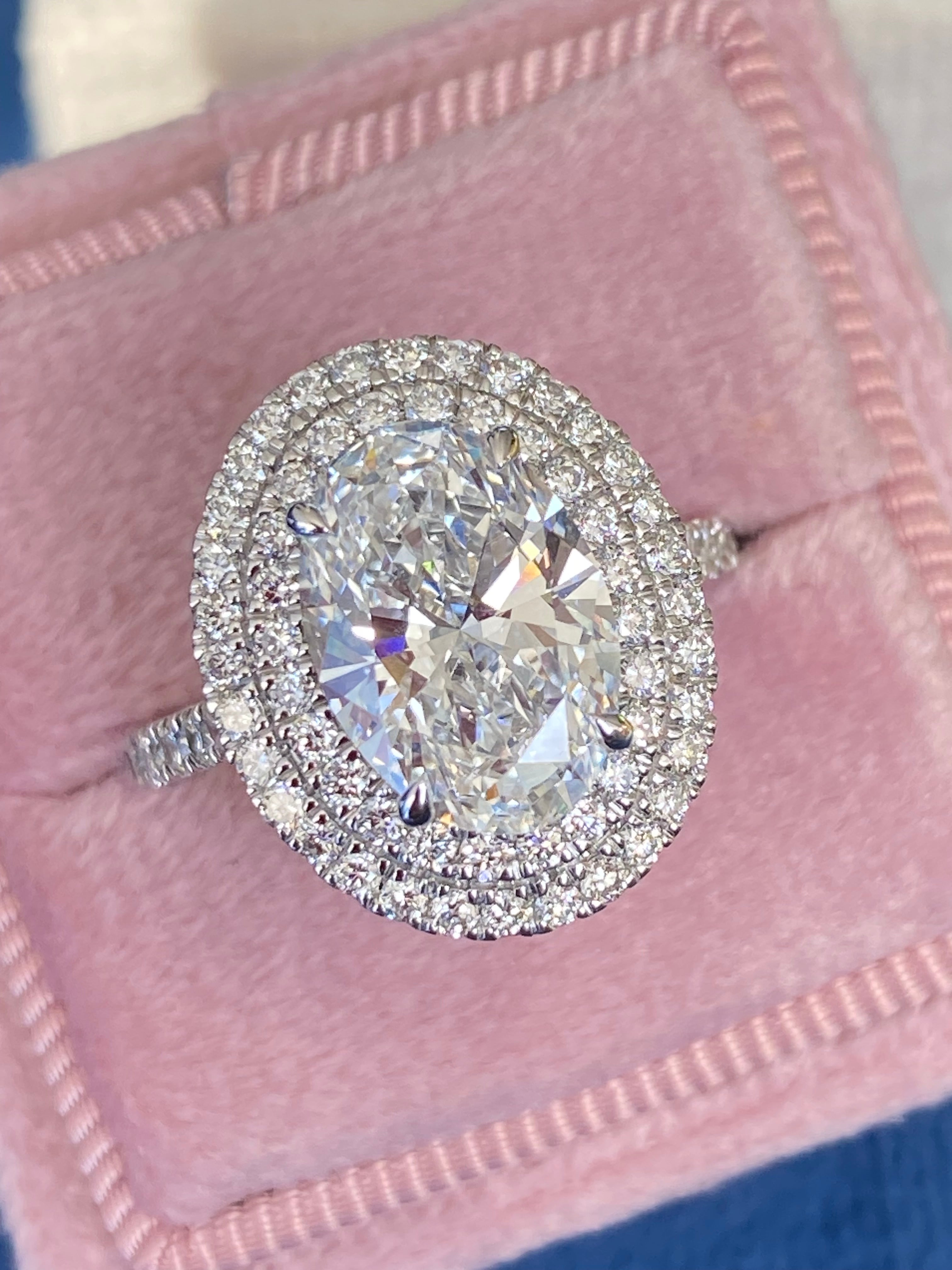 3.92 CTW Oval Cut Lab Diamond Double Halo Engagement Ring in Platinum