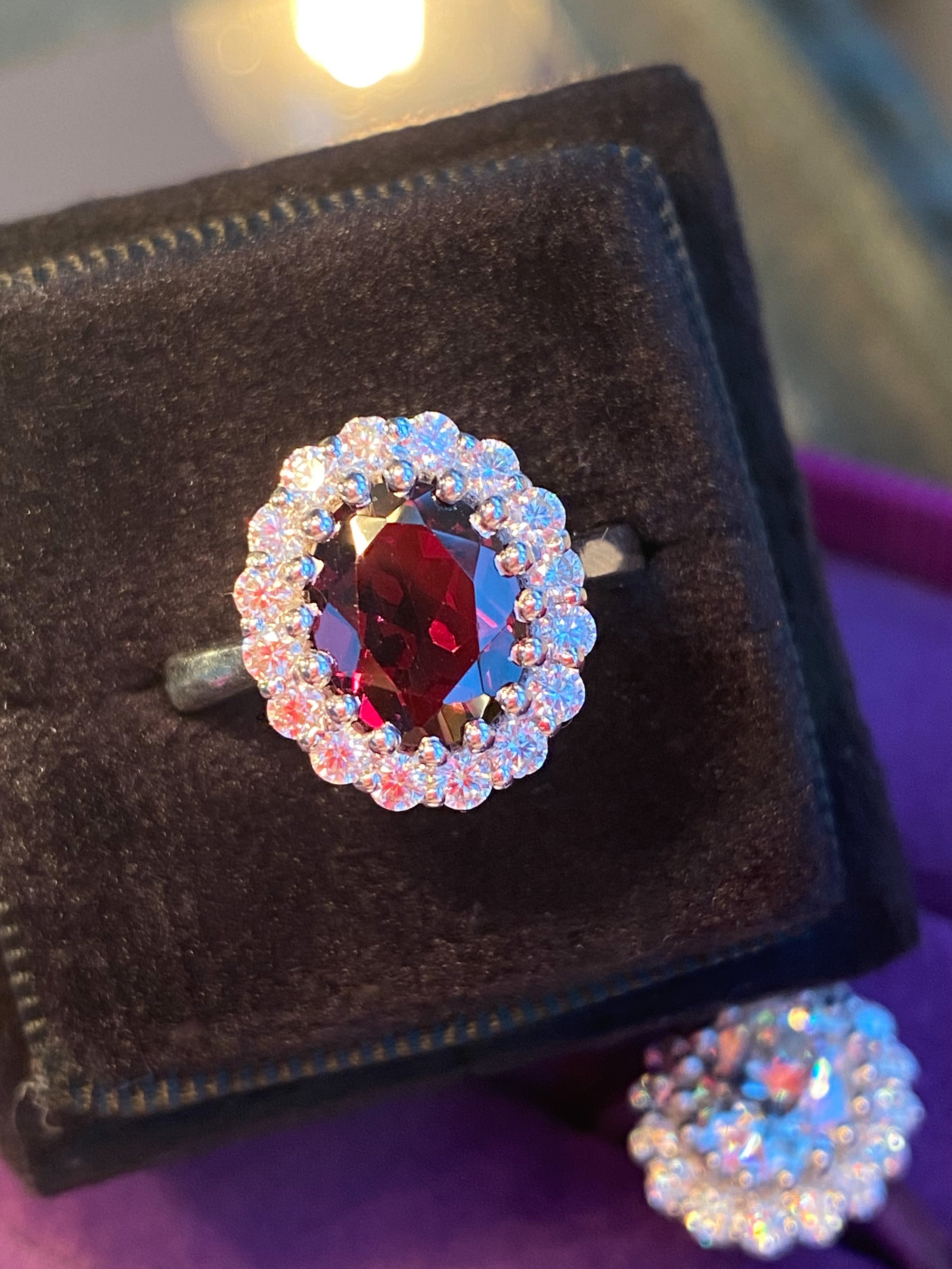 2.33 CTW Oval Cut Garnet and Moissanite Halo Ring in Sterling Silver