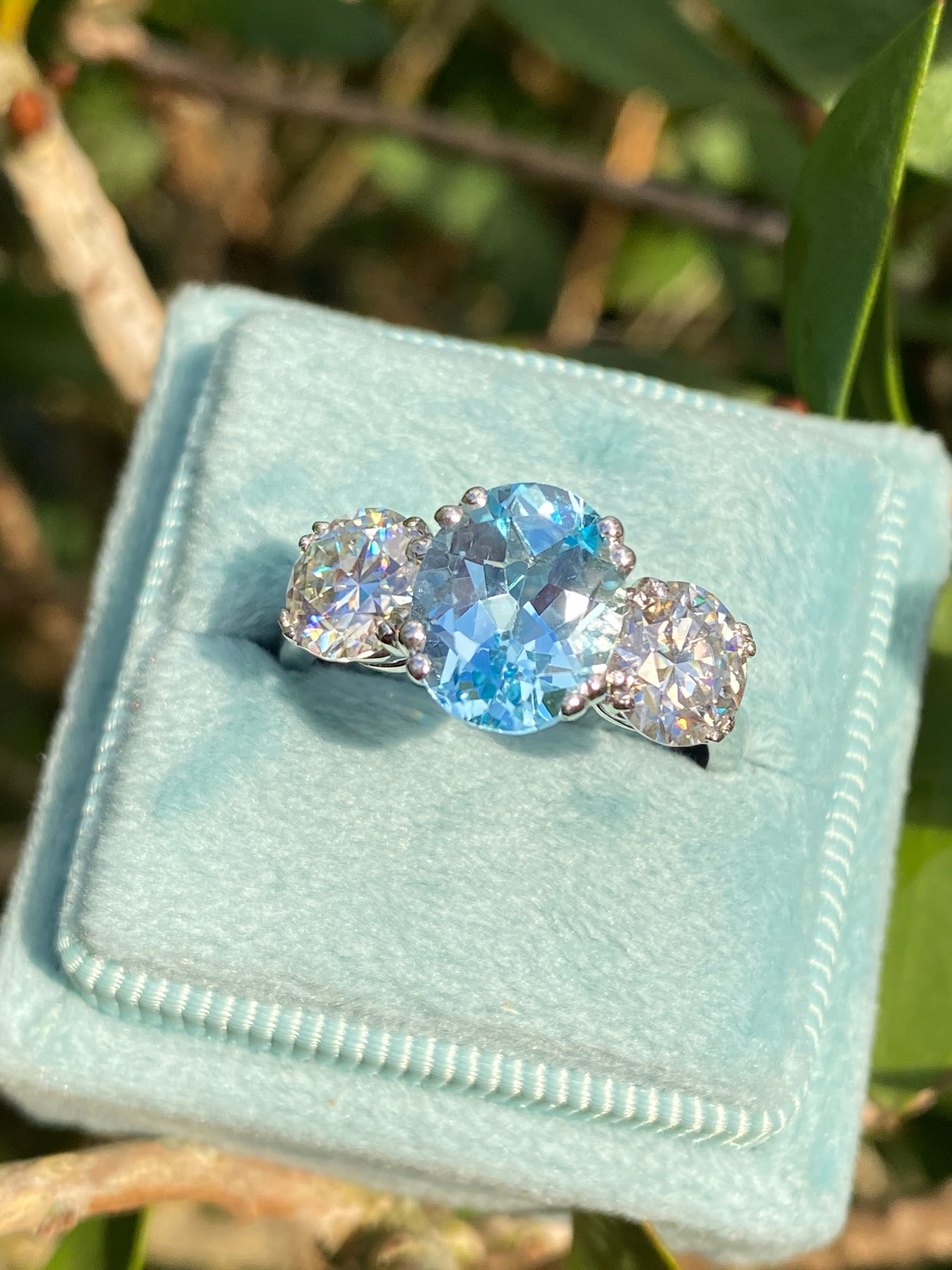 2.57 Carat Blue Topaz and 1.84 Carat Moissanite Three Stone Ring in Sterling Silver