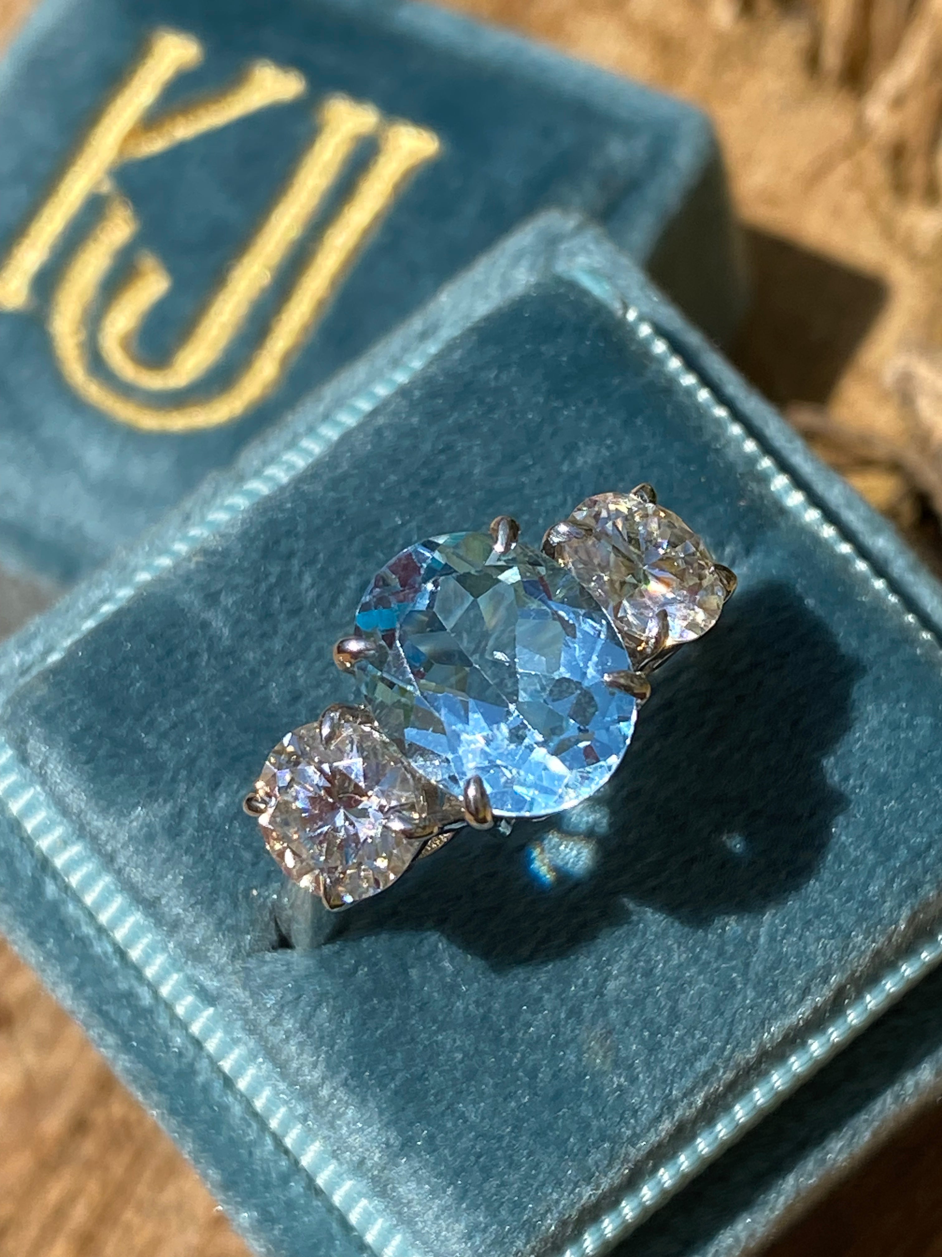 3.99 Carat Oval Cut Blue Topaz and 1.85 Carat Moissanite Three Stone Ring in Sterling Silver