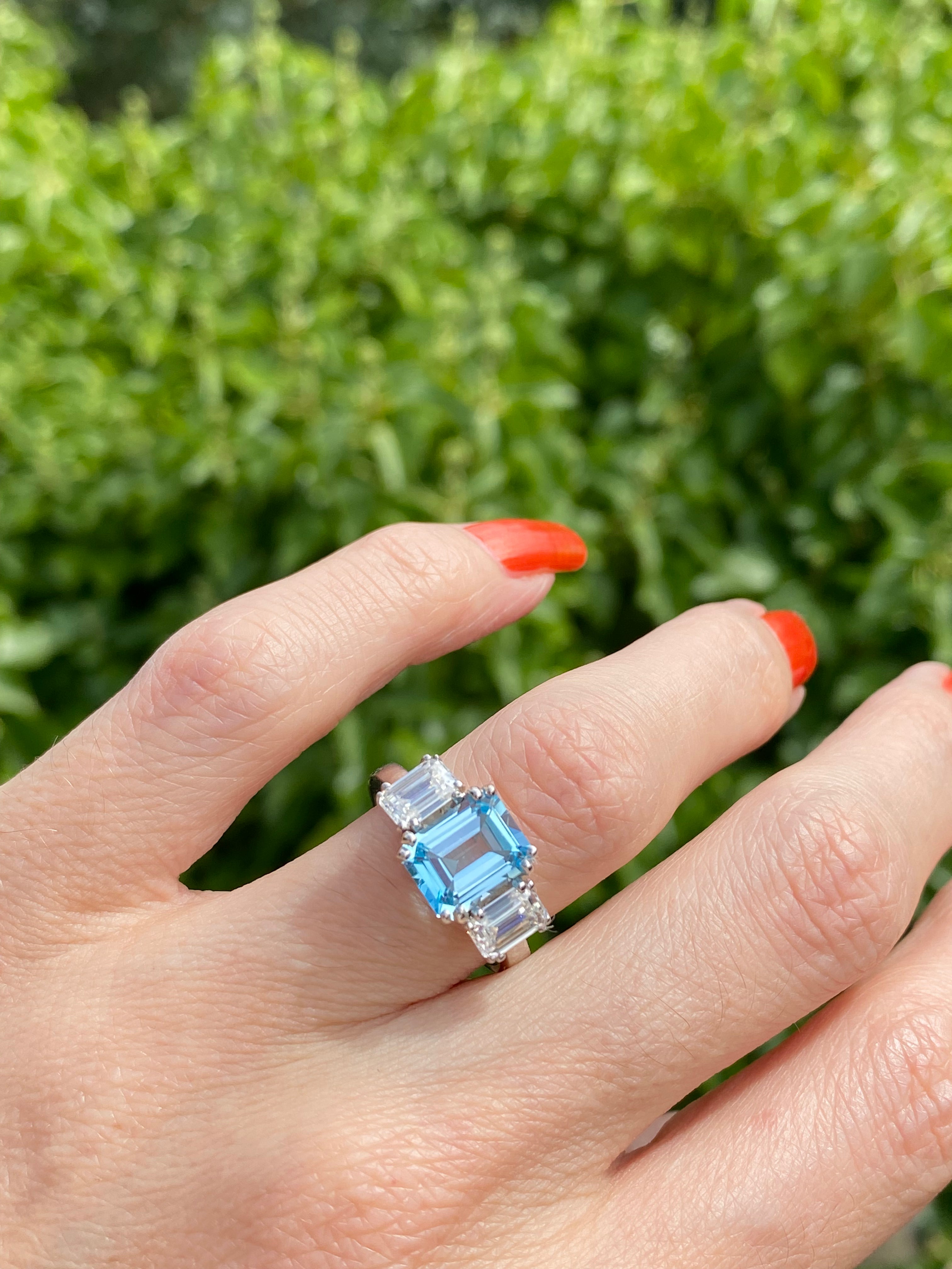 3.50 CTW Emerald Cut Blue Topaz and Moissanite Three Stone Ring in Sterling Silver
