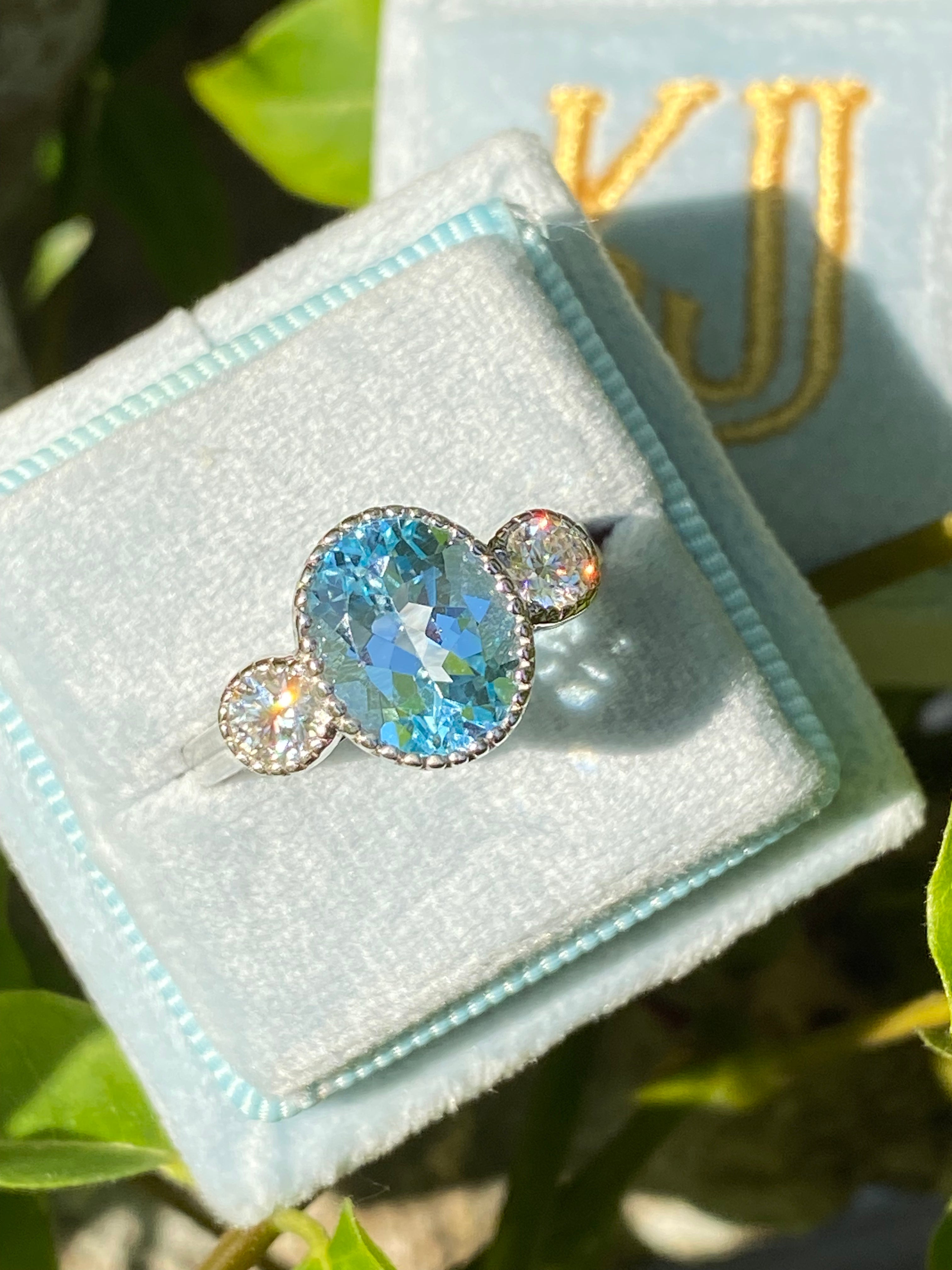 3.34 Carat Oval Cut Blue Topaz and Moissanite Three Stone Ring in Sterling Silver