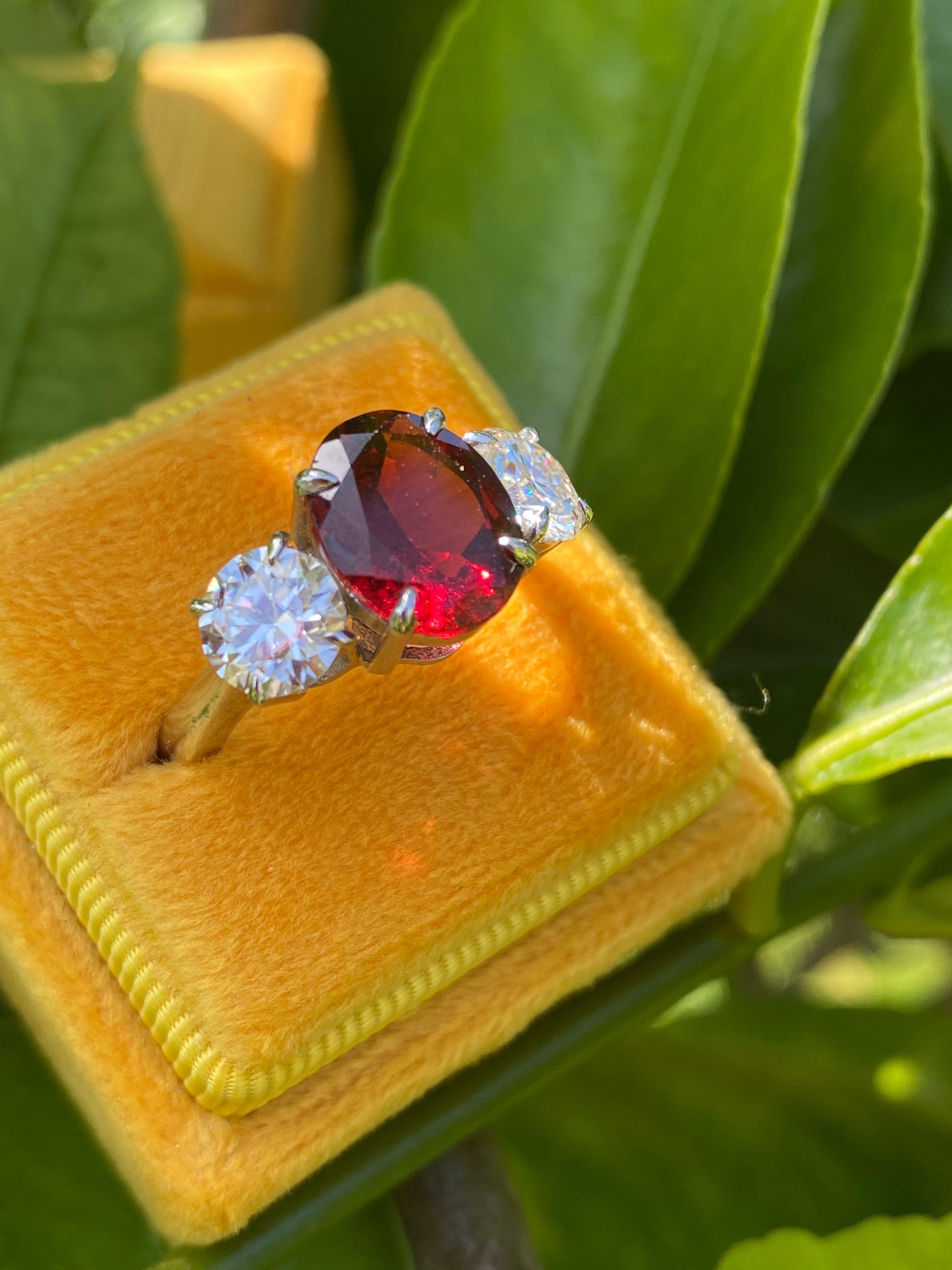 4.10 Carat Oval Cut Garnet and 1.85 Carat Moissanite Three Stone Ring in Sterling Silver
