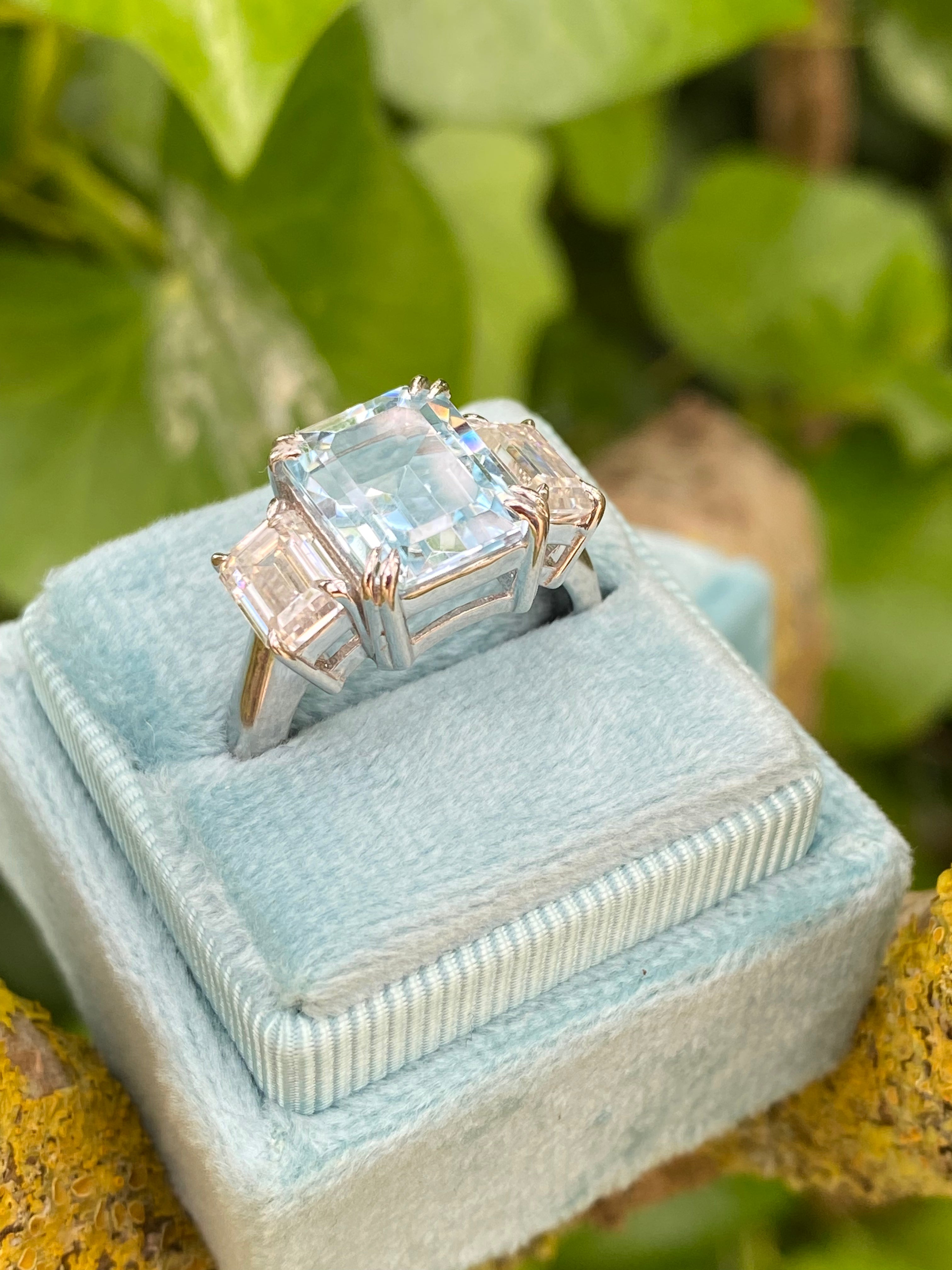 5.71 Carat Emerald Cut Blue Topaz and 2.00 Carat Moissanite Three Stone Ring in Sterling Silver