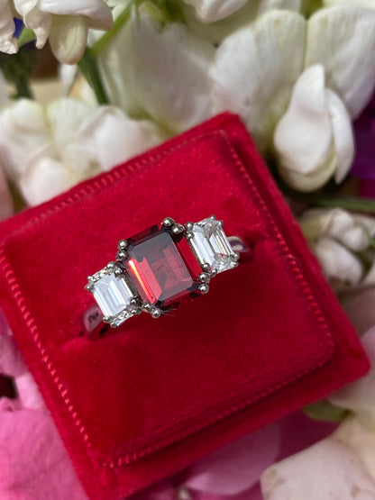 3.50 CTW Emerald Cut Garnet and Moissanite Three Stone Ring in Sterling Silver