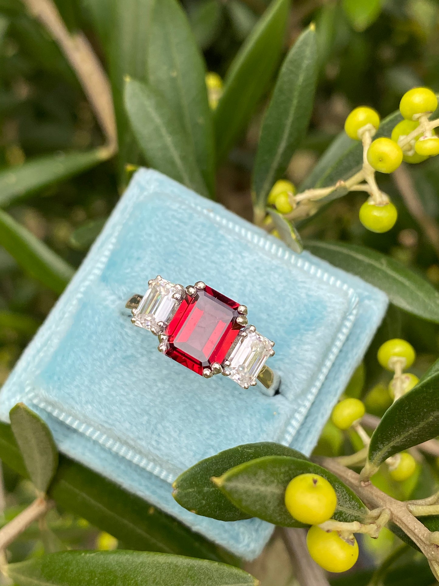 3.50 CTW Emerald Cut Garnet and Moissanite Three Stone Ring in Sterling Silver