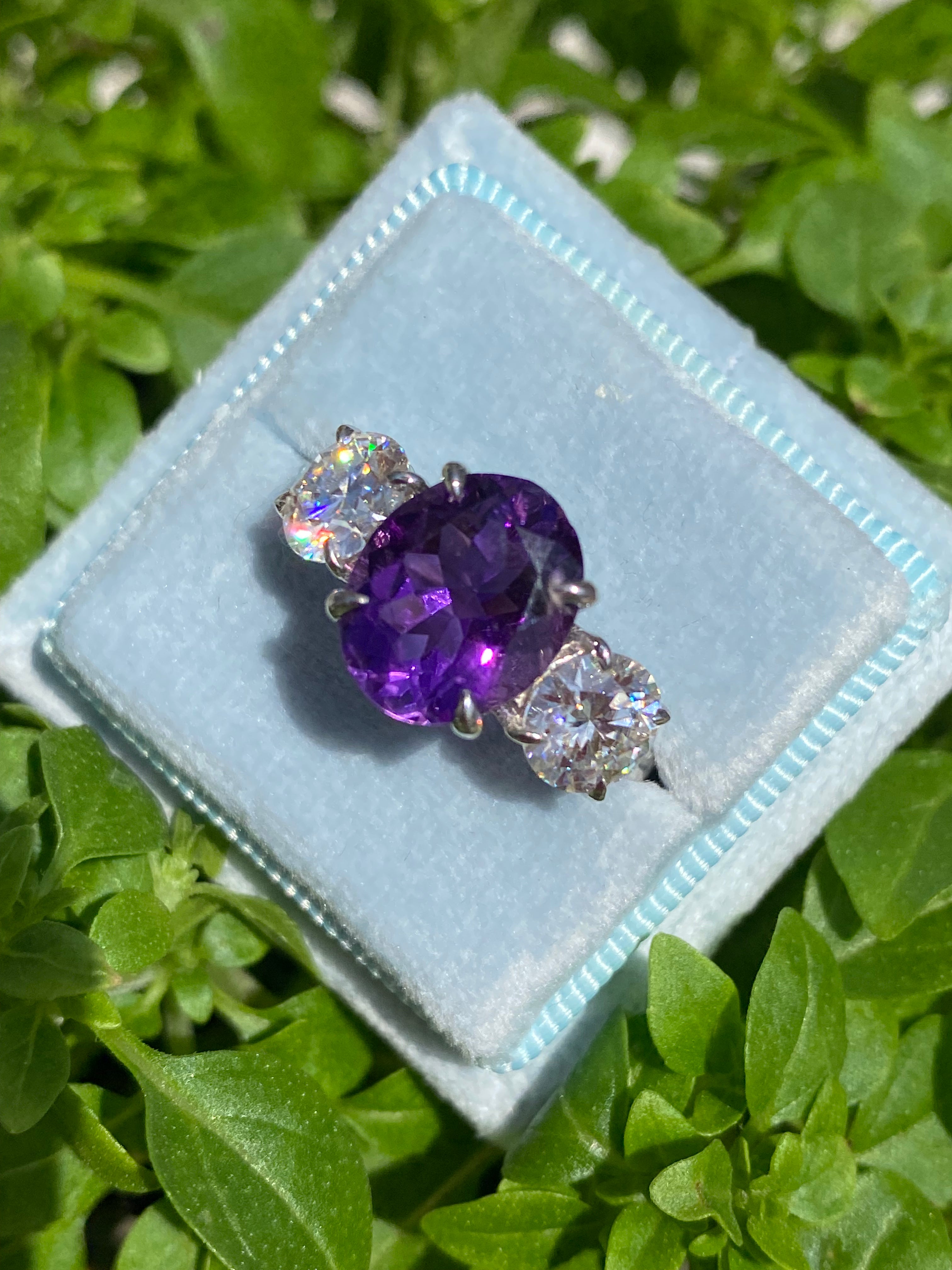 3.42 Carat Oval Cut Amethyst and 1.85 Carat Moissanite Three Stone Ring in Sterling Silver