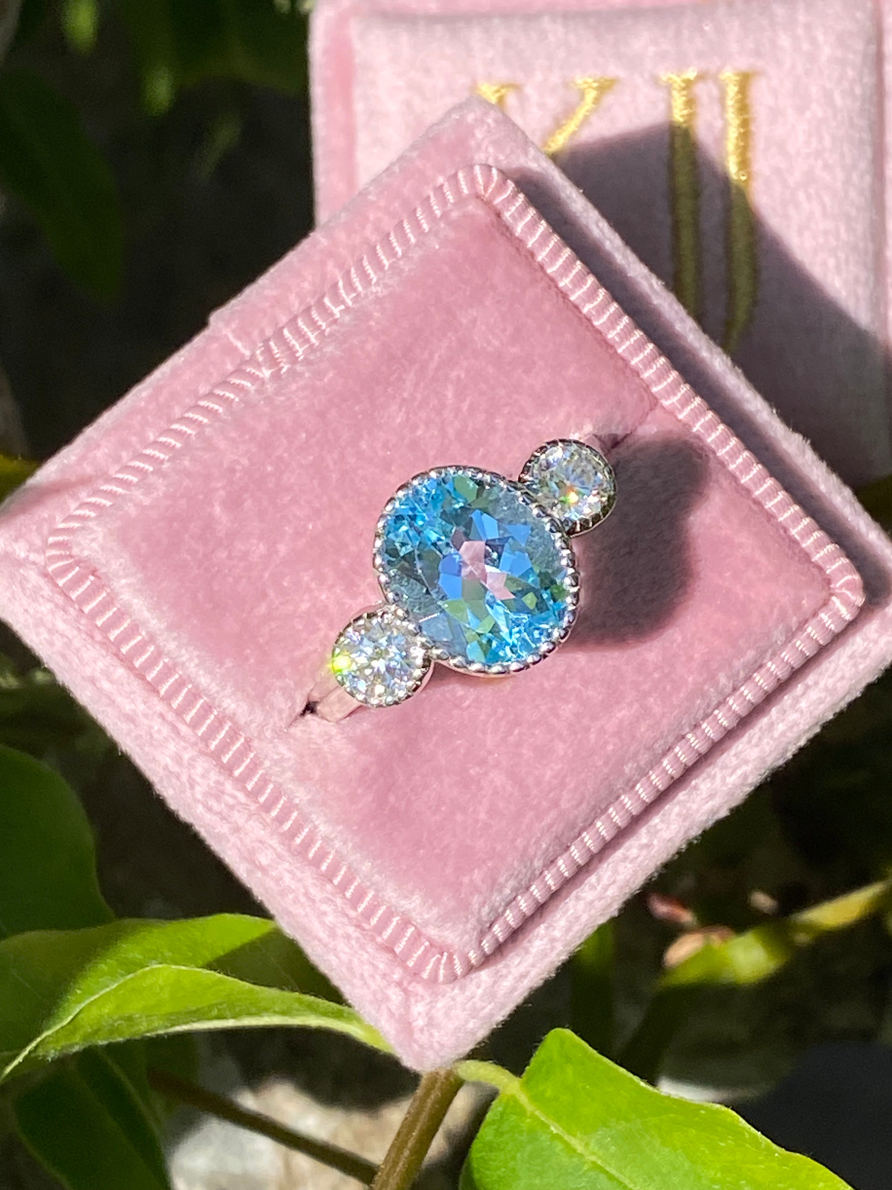 3.34 Carat Oval Cut Blue Topaz and Moissanite Three Stone Ring in Sterling Silver